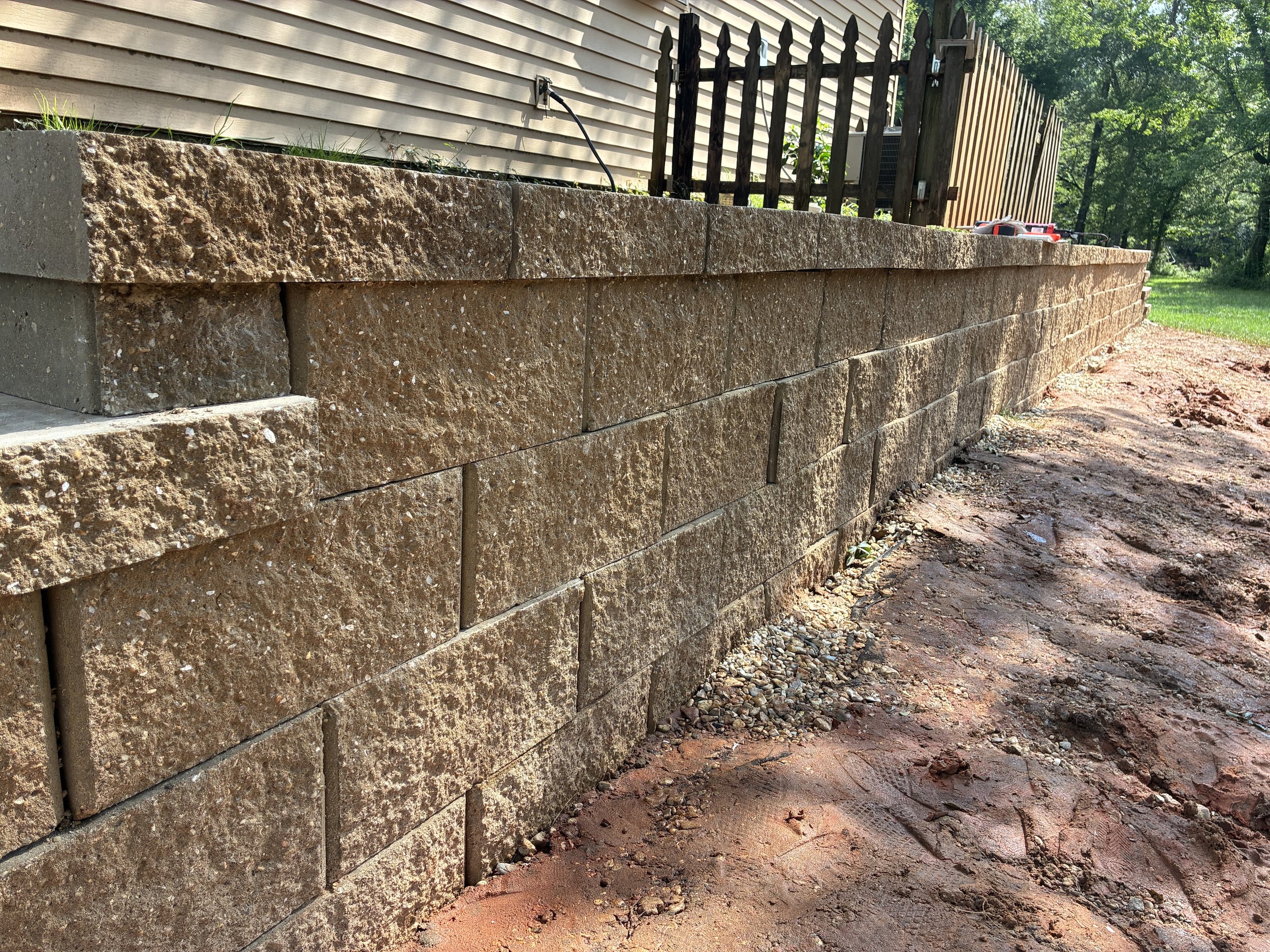 close up of 4 brick high retaining wall looking down