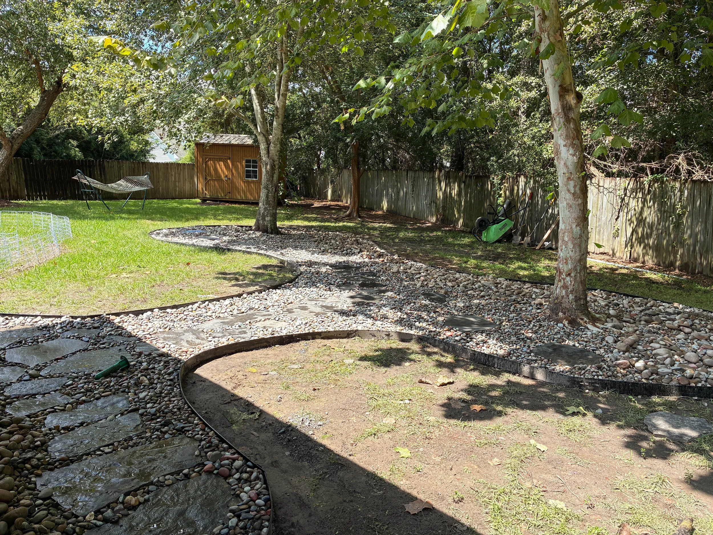flagstone walkway with rocks going around trees