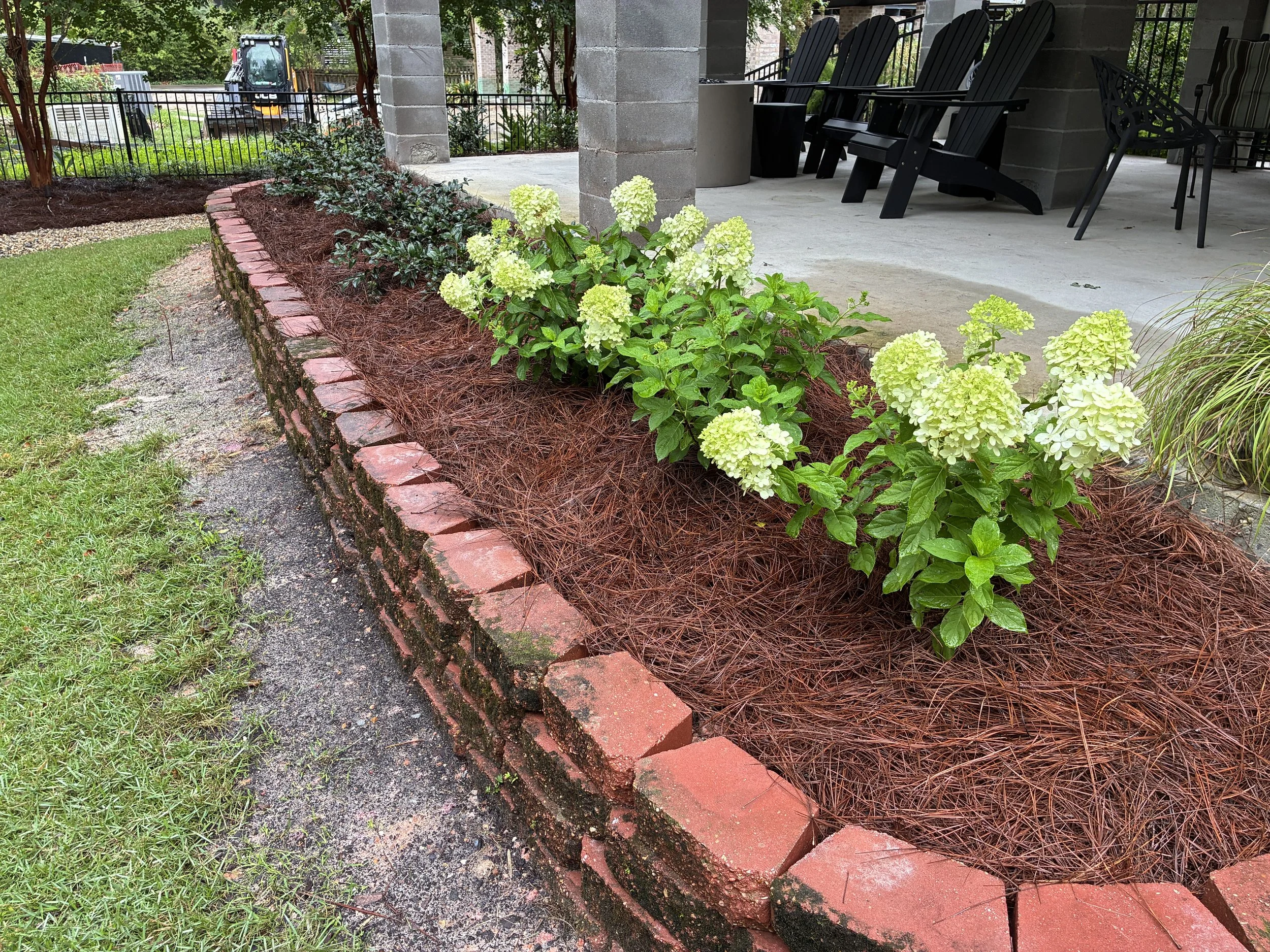 another elevated garden bed by a small retaining wall