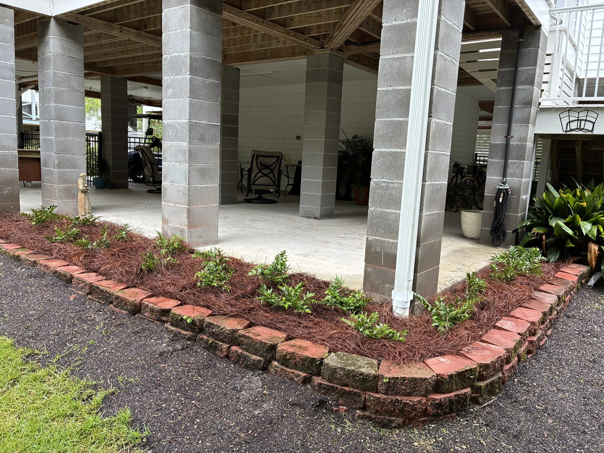 corner wrap around garden bed elevated with a small retaining wall