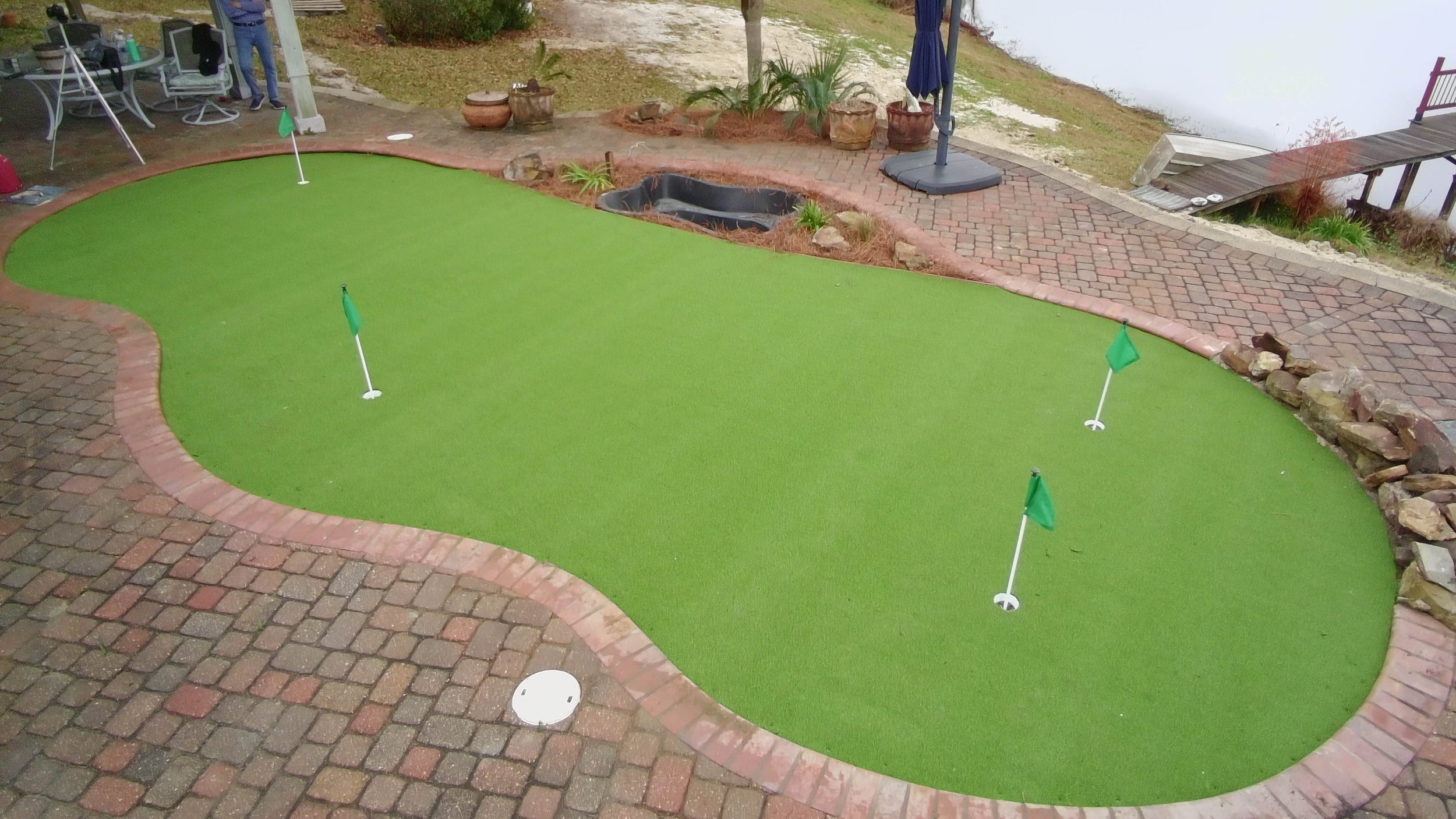 drone image of putting greens install into an old leaking and cracked pool