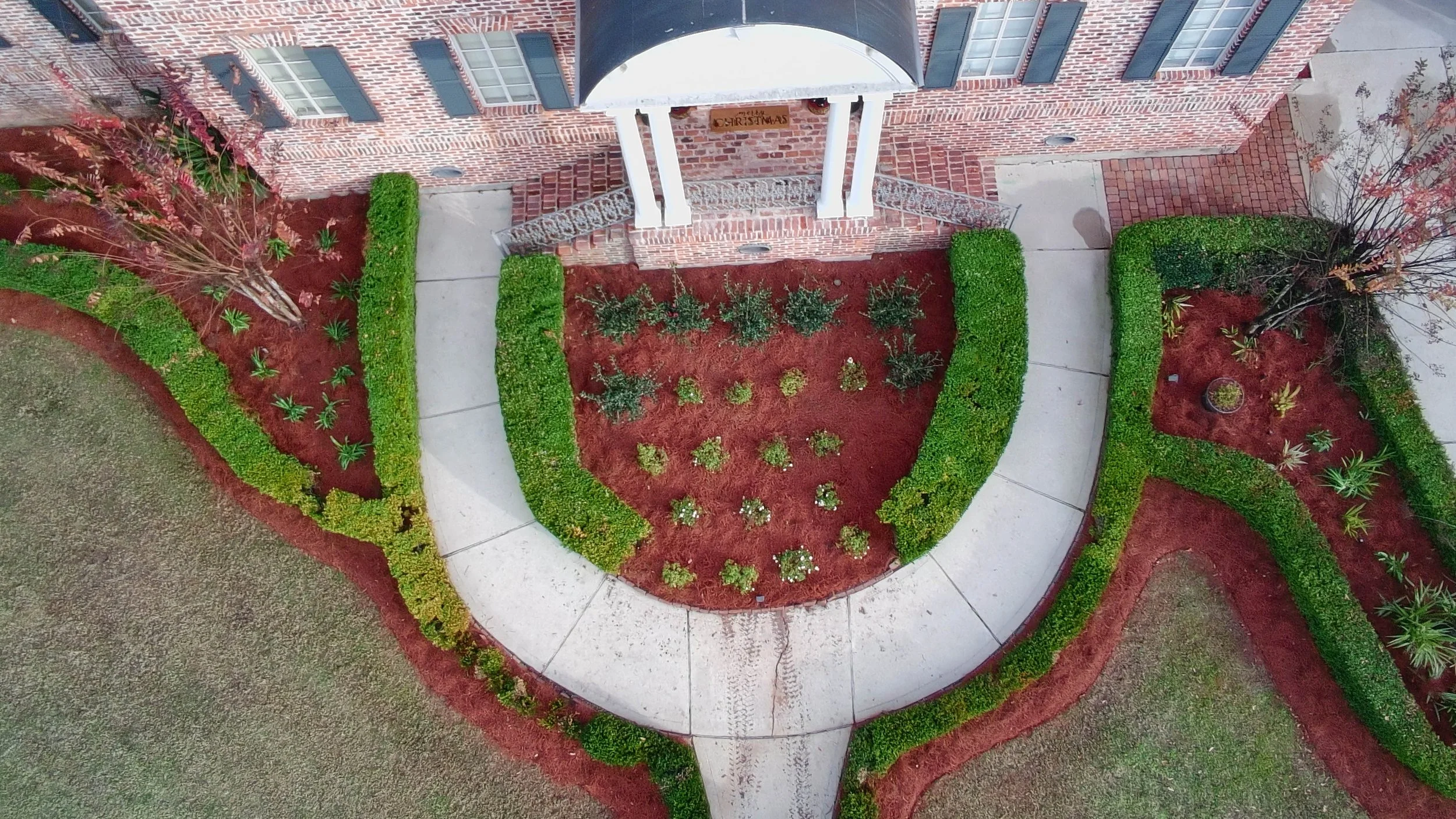 drone picture of a garden bed that is in a semi circle shaped by the pathway.