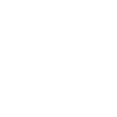 A woman with glasses talking on a phone while sitting on a brown couch with a laptop in front of her, in a room with large windows, green plants, and modern decor.