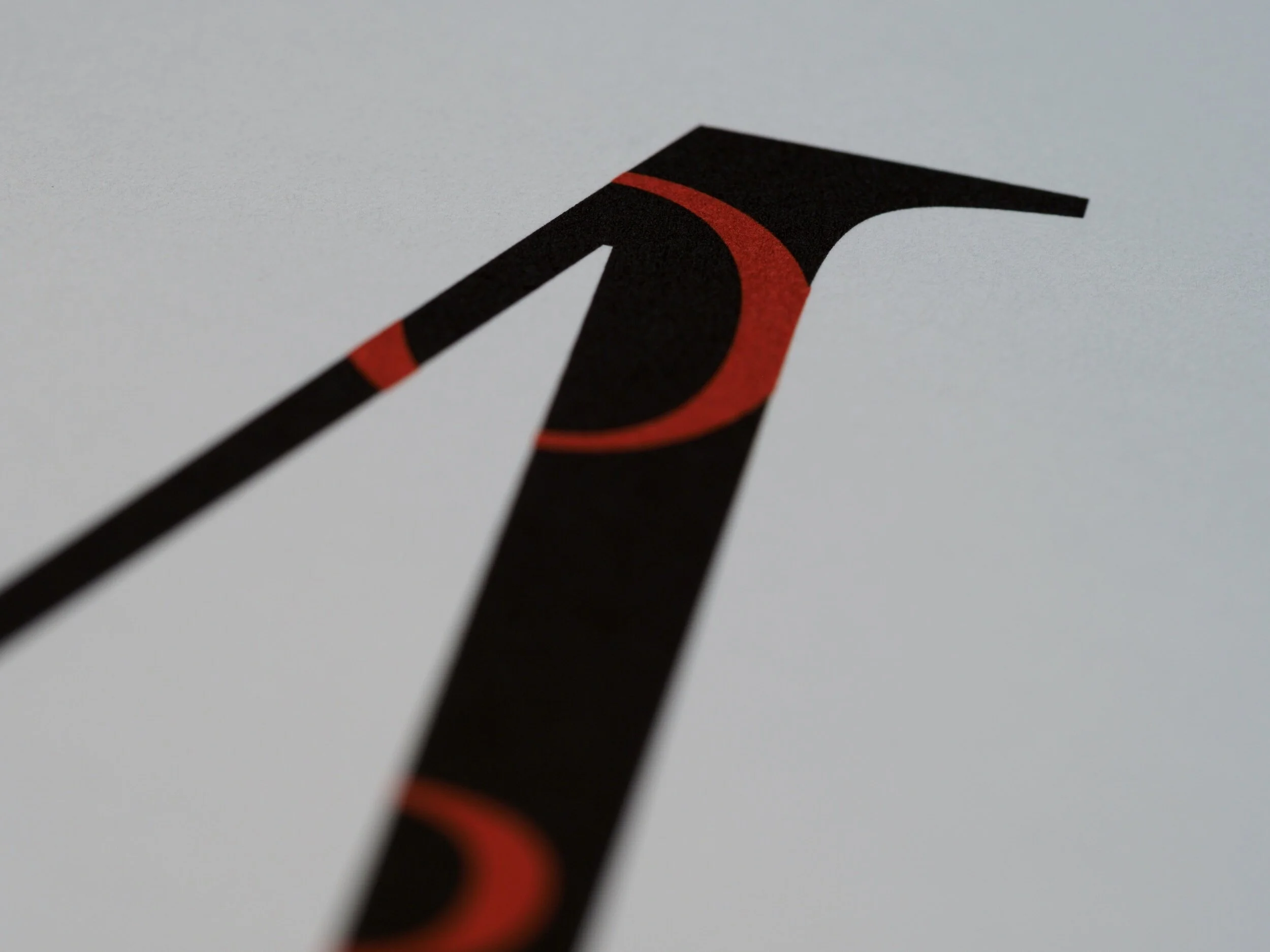 A close up of a letter A printed out with a swirl pattern within the A shape