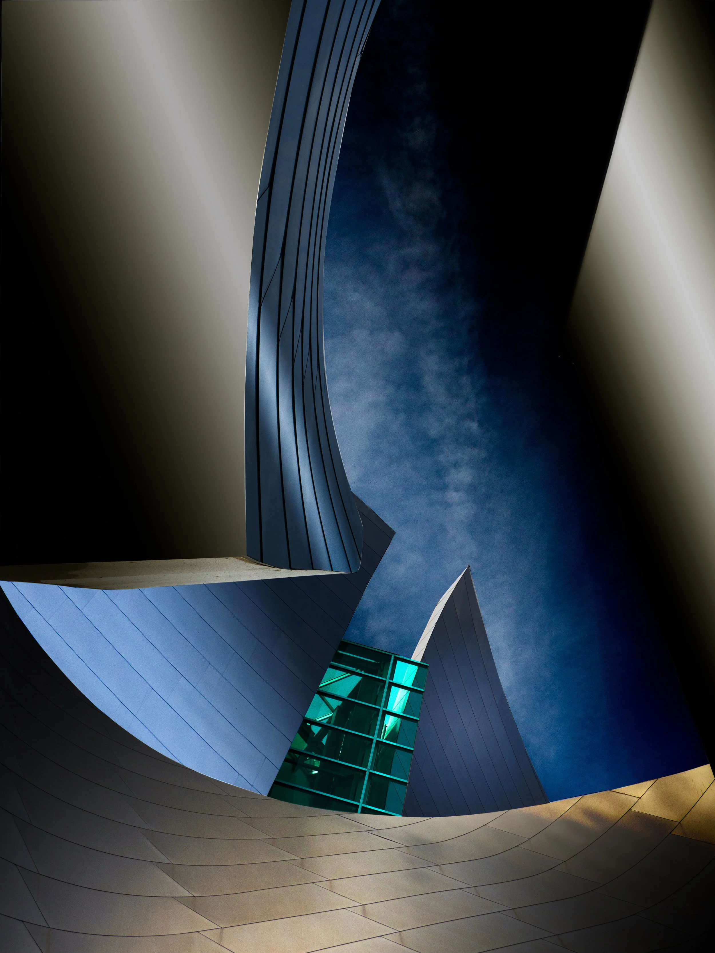Abstract low-angle view of a futuristic building with curved metallic panels, sharp architectural forms, and turquoise glass against a dark blue sky