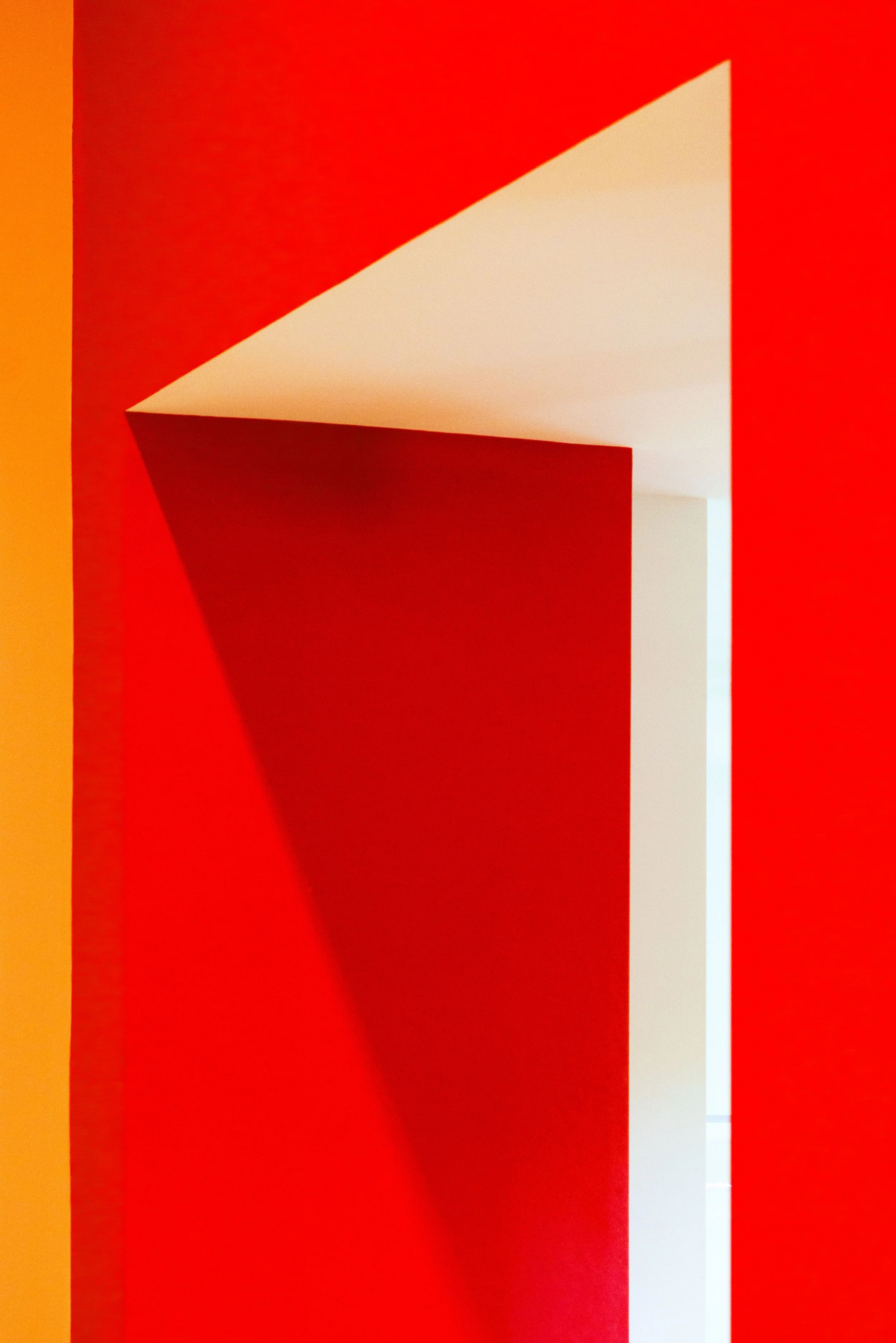 Abstract red and cream geometric architectural structure with angled surfaces