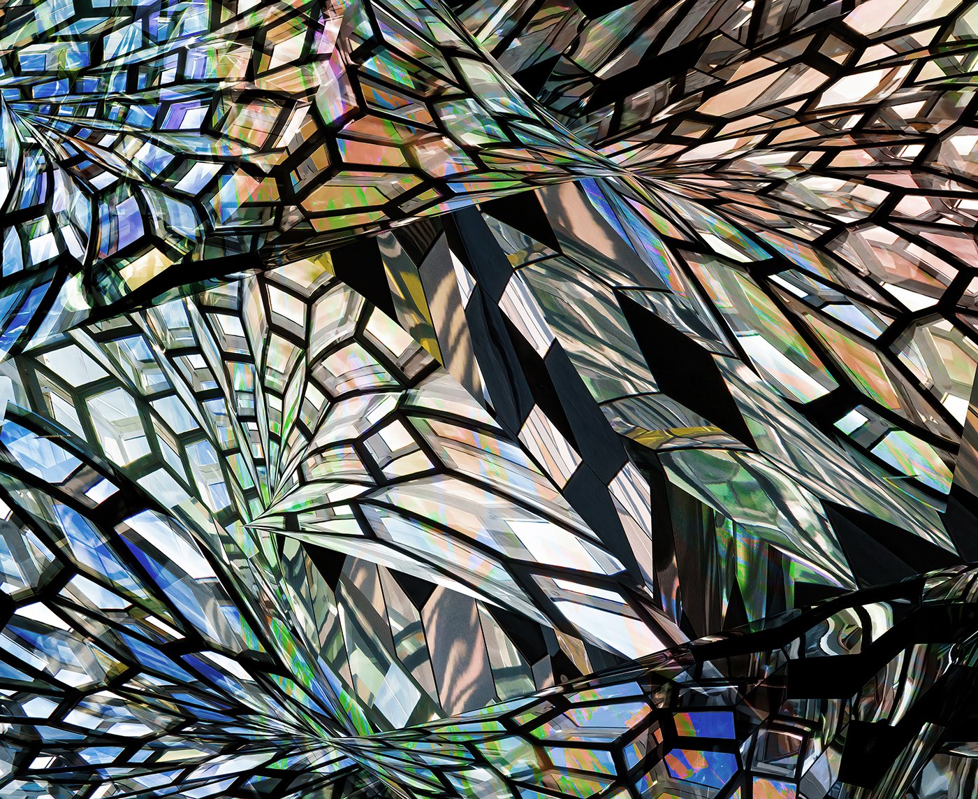 Abstract stained-glass pattern with multicolored geometric shards and black leading lines