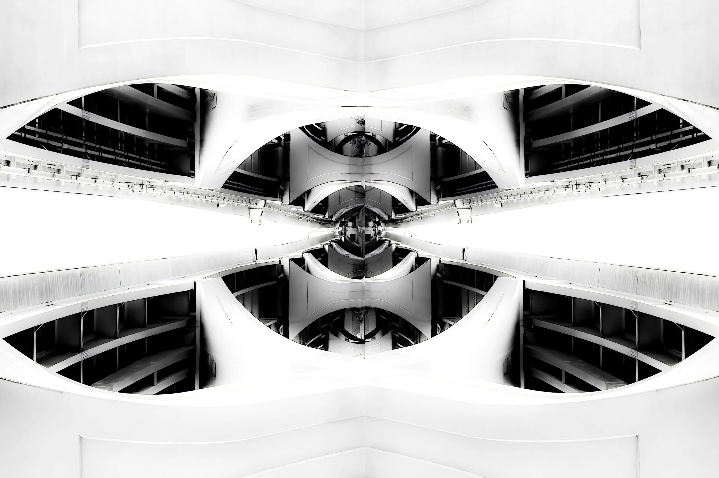 Black-and-white mirrored view of a modern interior with sweeping curved arches, balconies, and dramatic geometric architecture