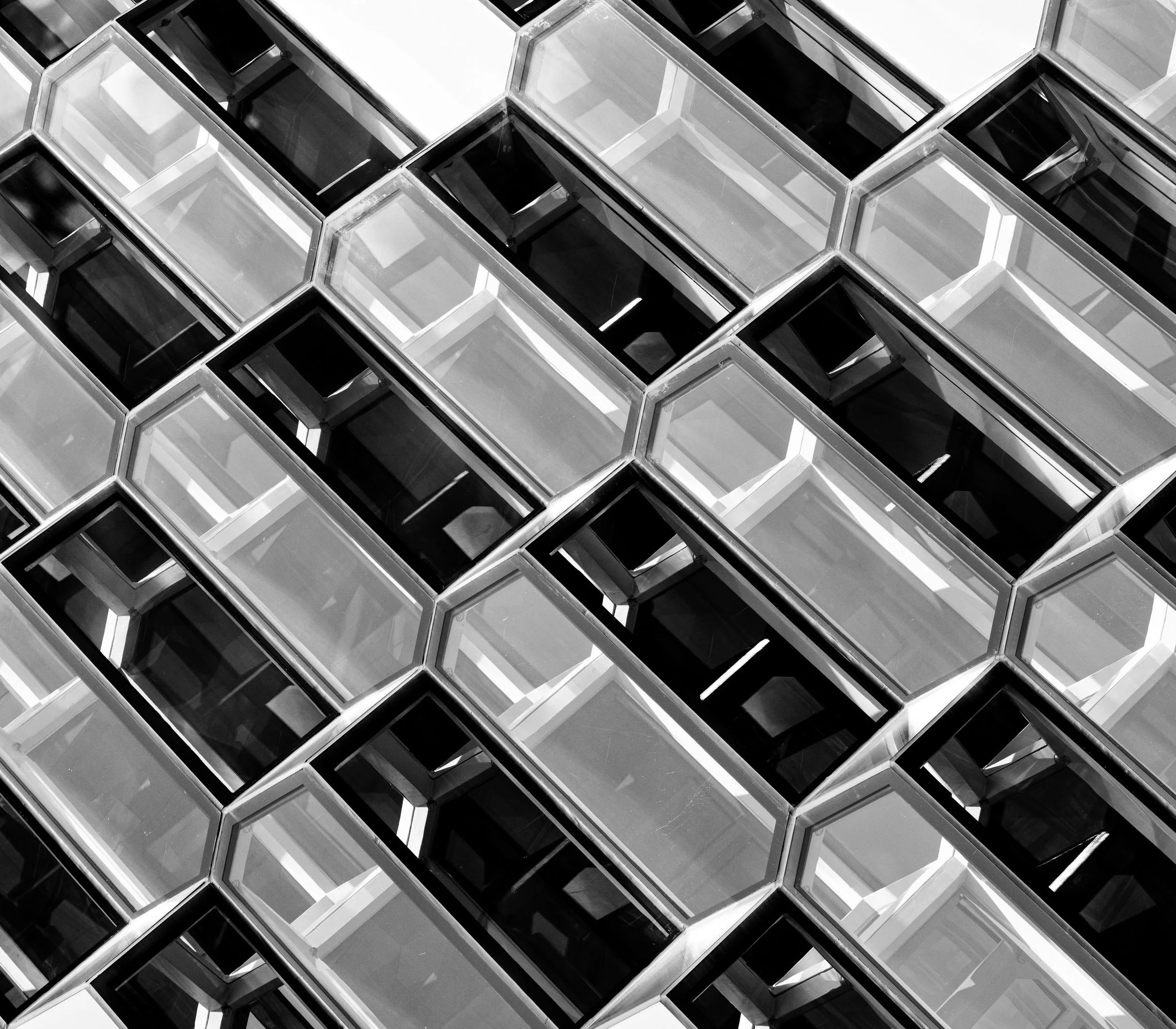 Abstract black-and-white pattern of overlapping glass skylights and geometric window frames
