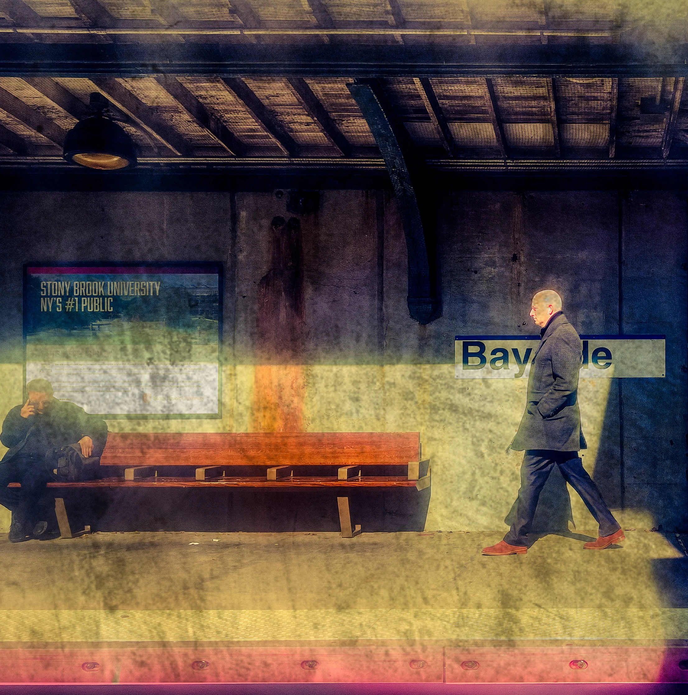 Two men at a subway station bench beneath signs for Stony Brook University and Bayle