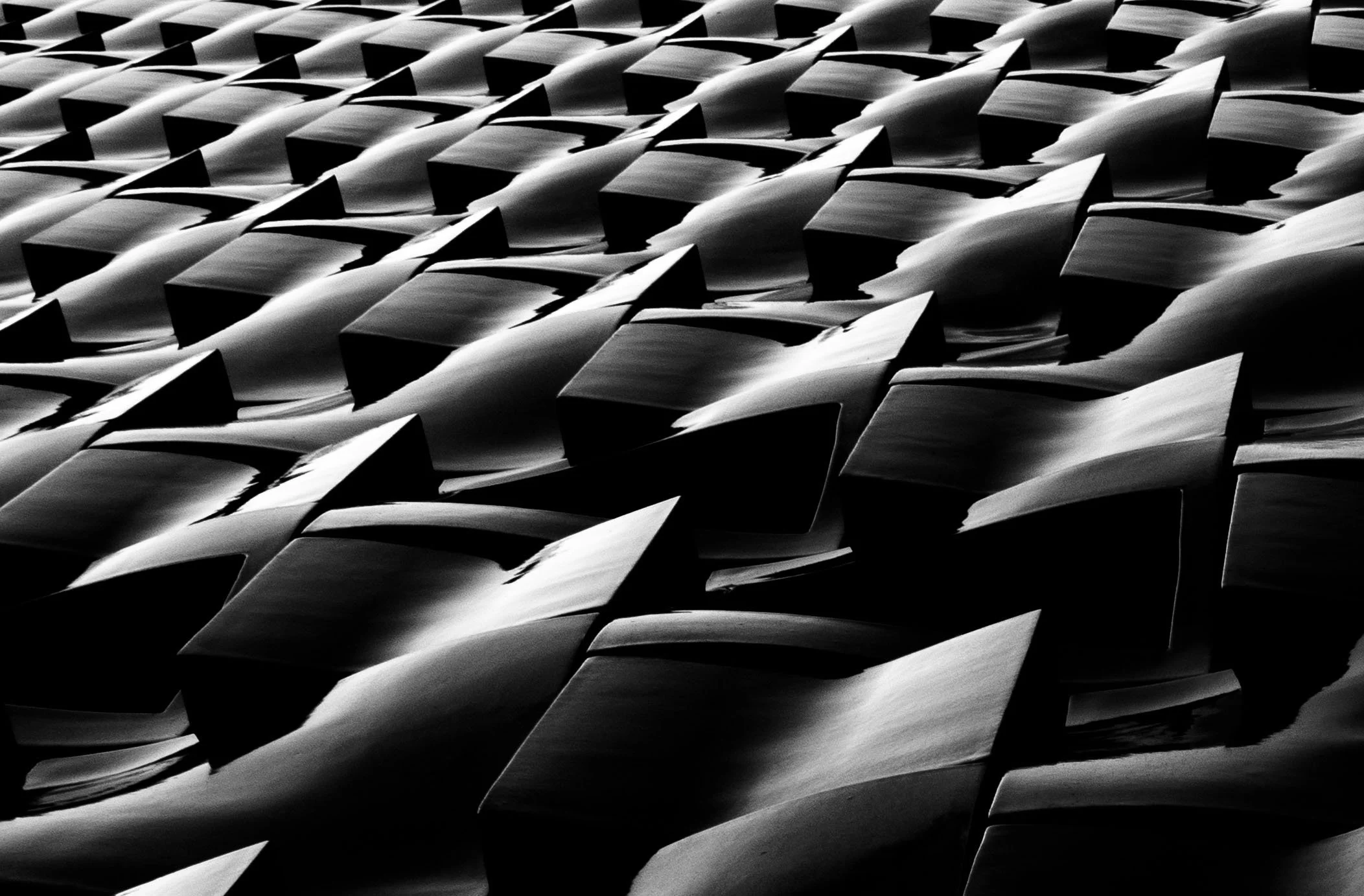 Abstract black-and-white pattern of overlapping folded geometric forms