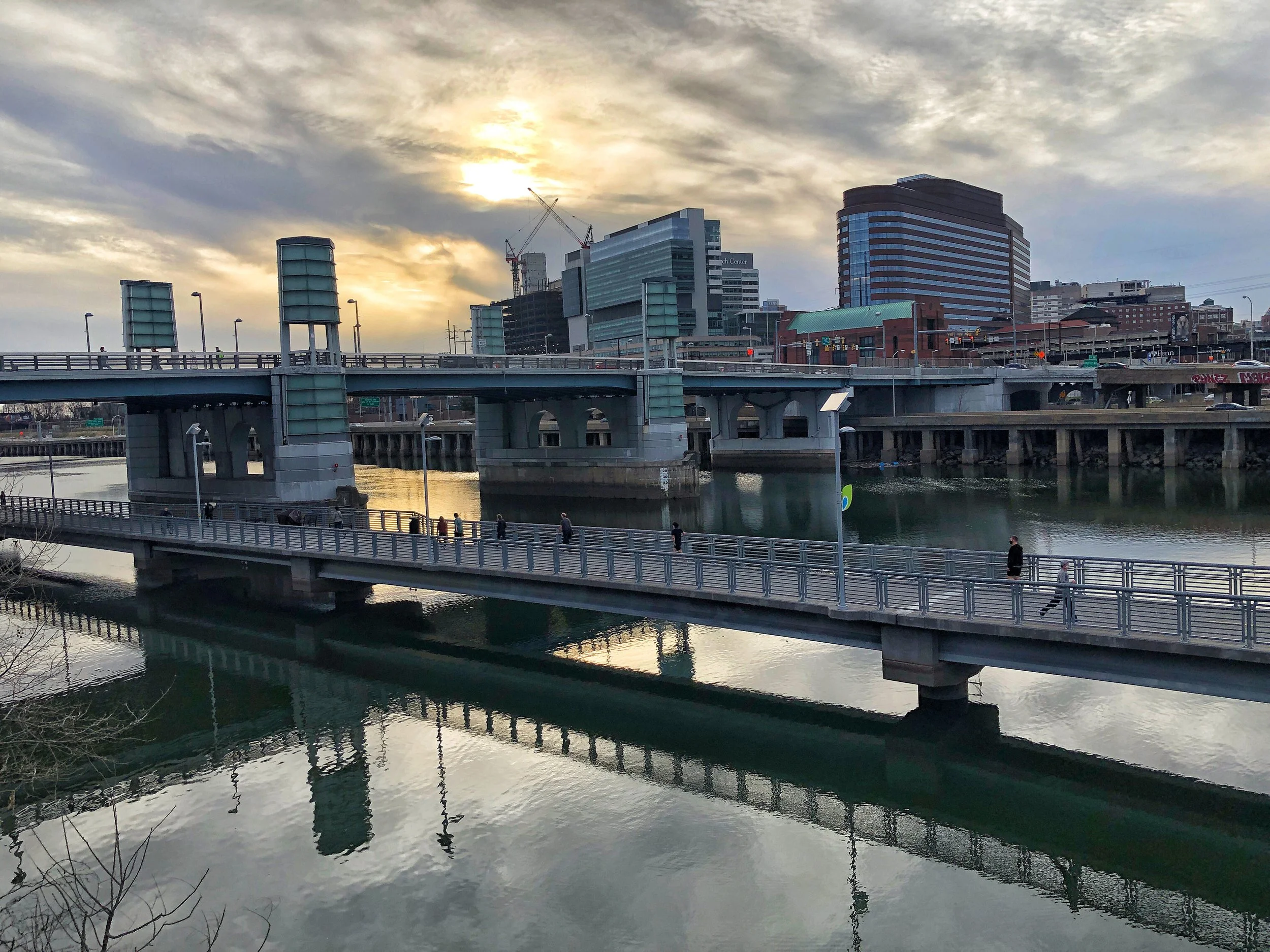 Sunset over downtown Providence, Rhode Island, with bridges crossing the Providence River and the Providence skyline in the background