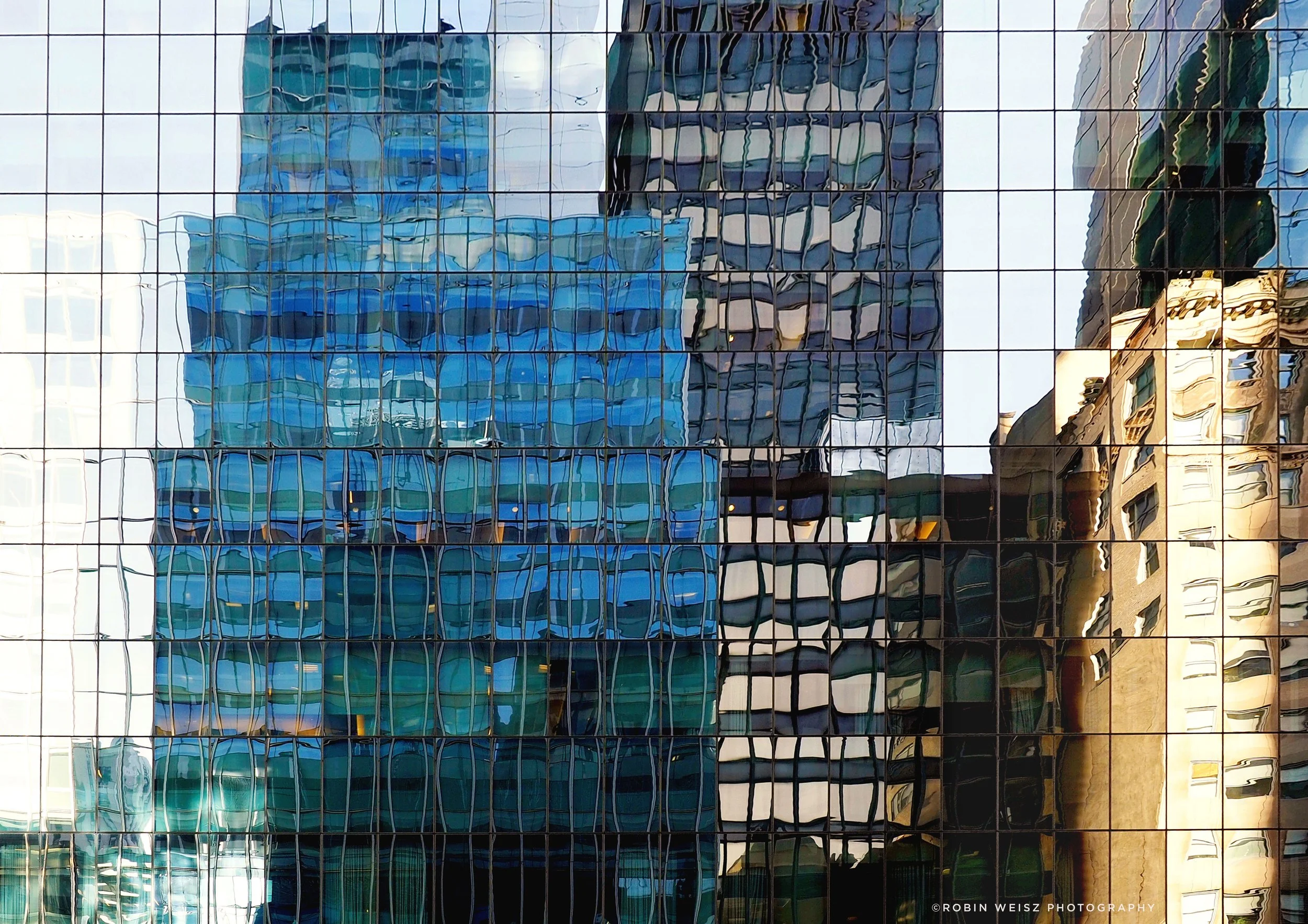 Abstract reflection of modern city buildings in a glass skyscraper facade.