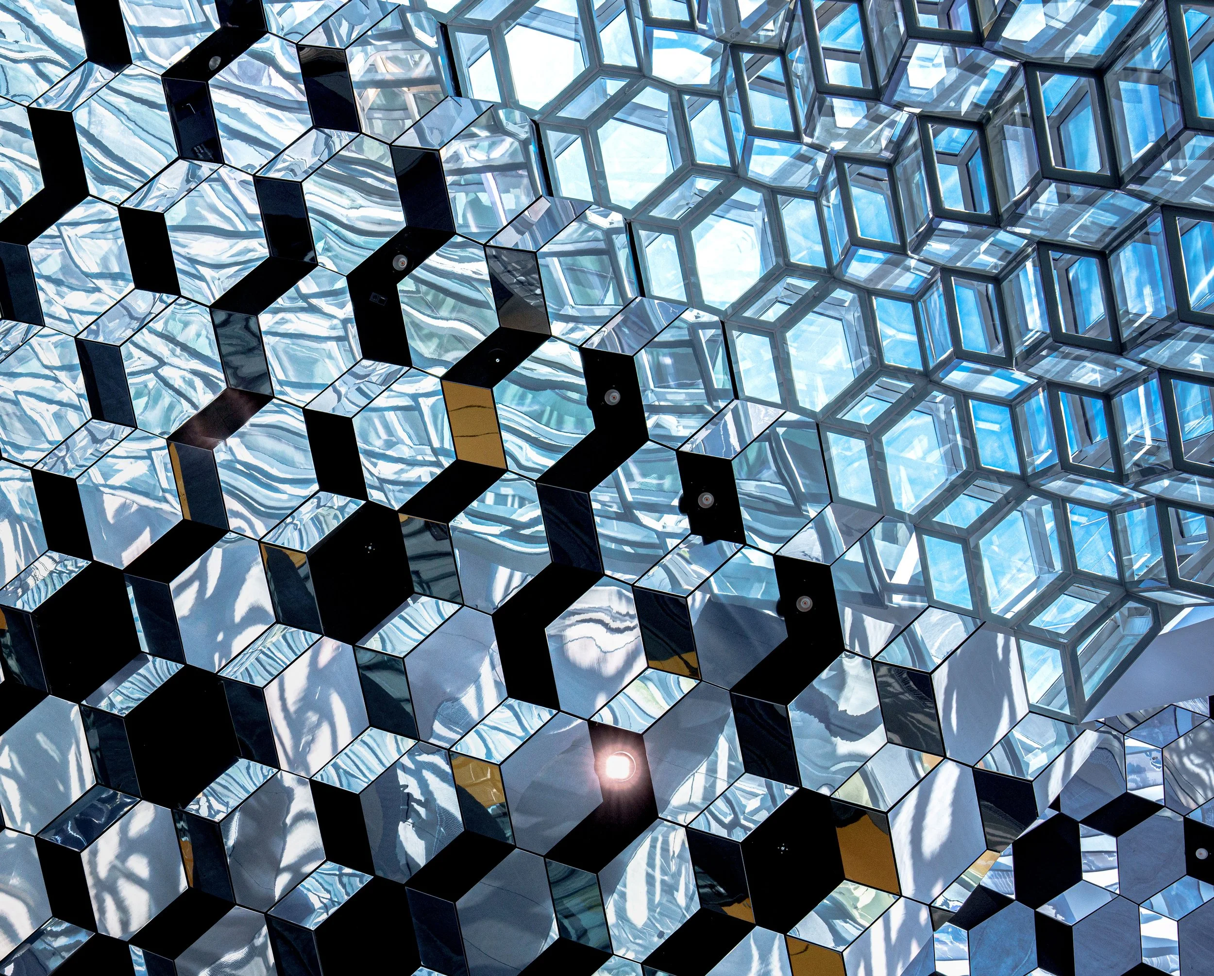 Abstract geometric ceiling installation with mirrored and blue glass cubes in a modern interior