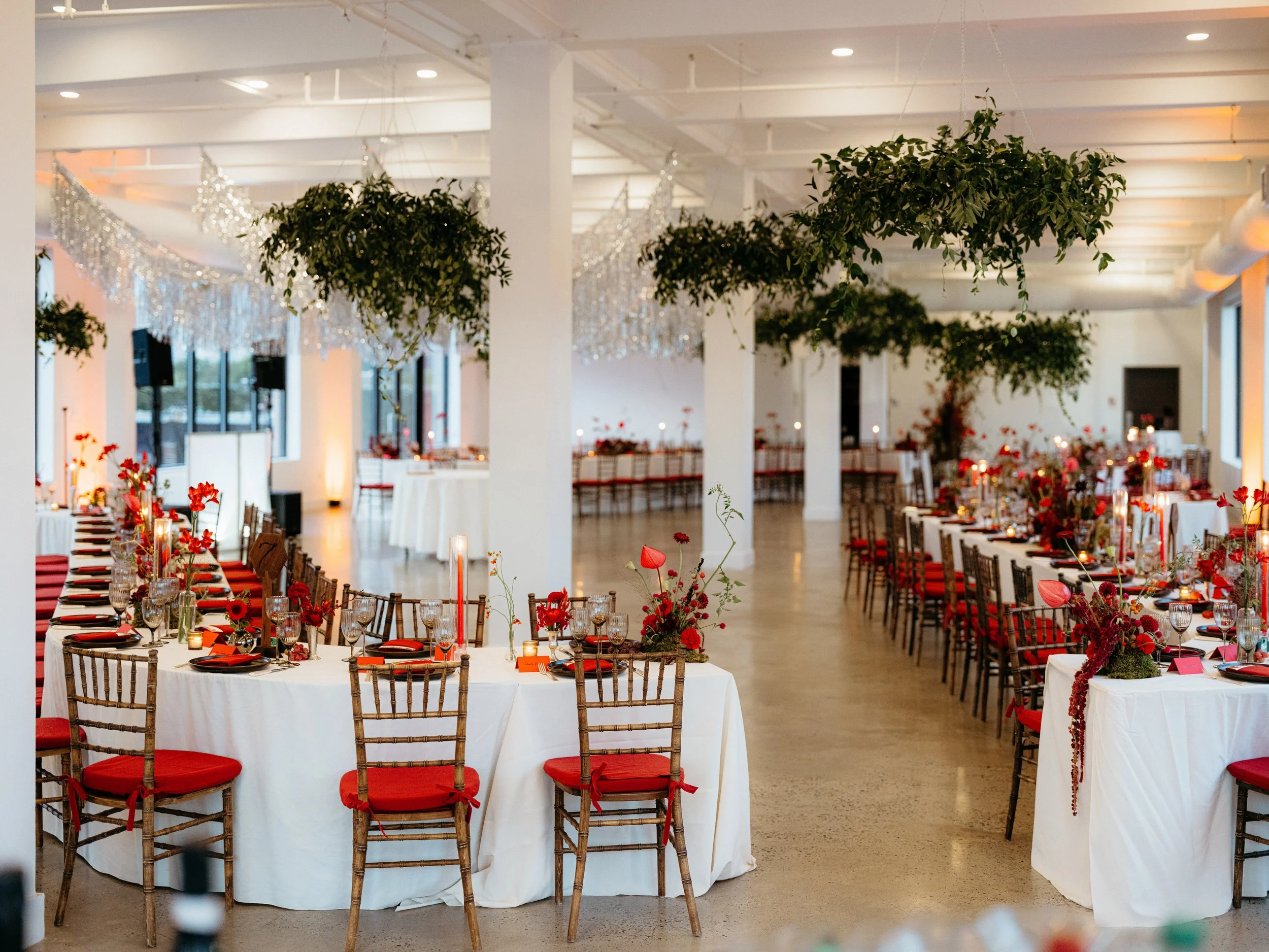 Curved tables and hanging greenery at NYC loft wedding