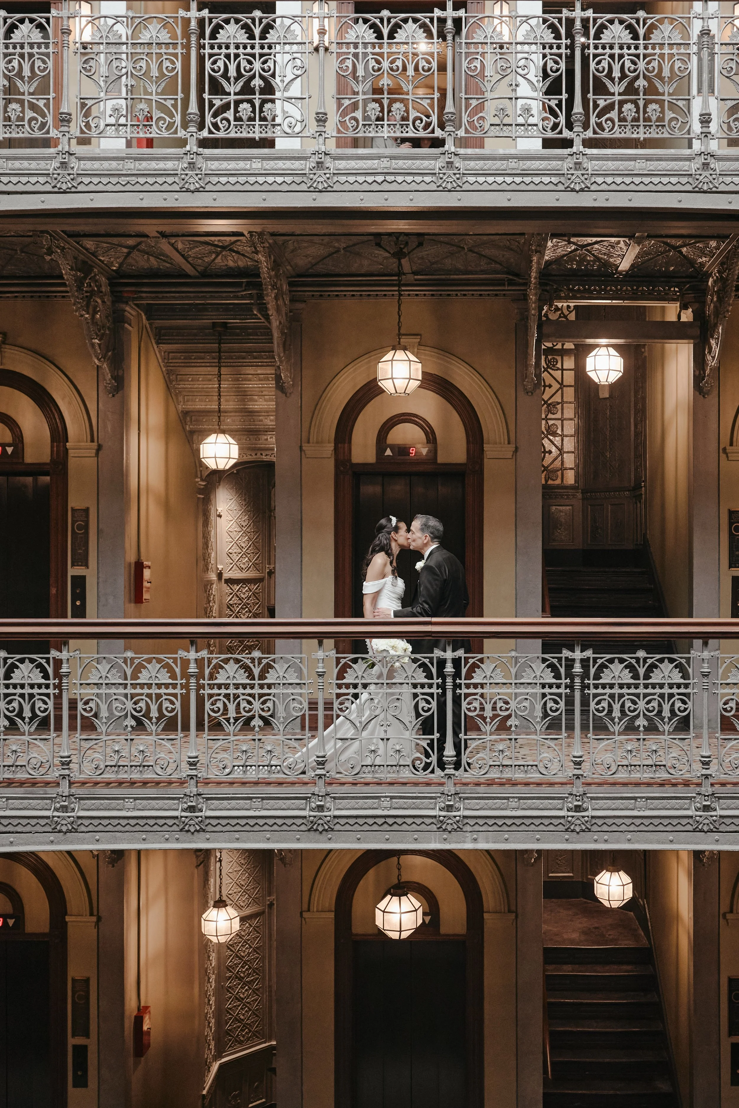 Bride and groom kiss on balcony at New York wedding