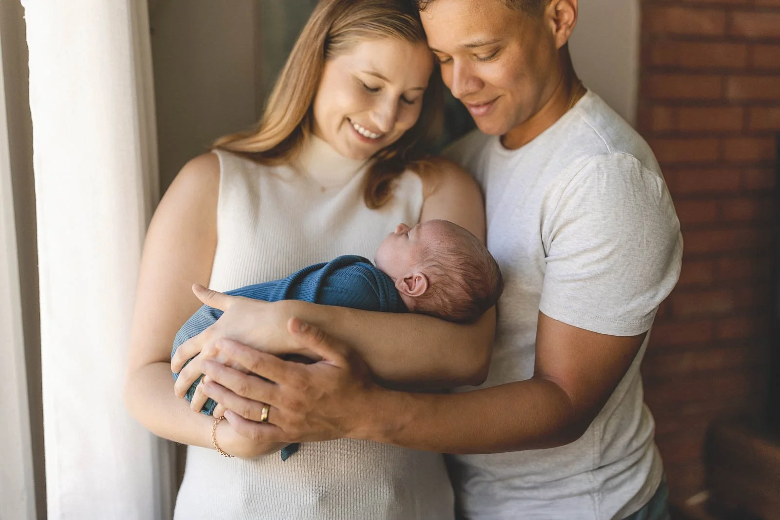 parents holding baby during photoshoot with orange county newborn photographer