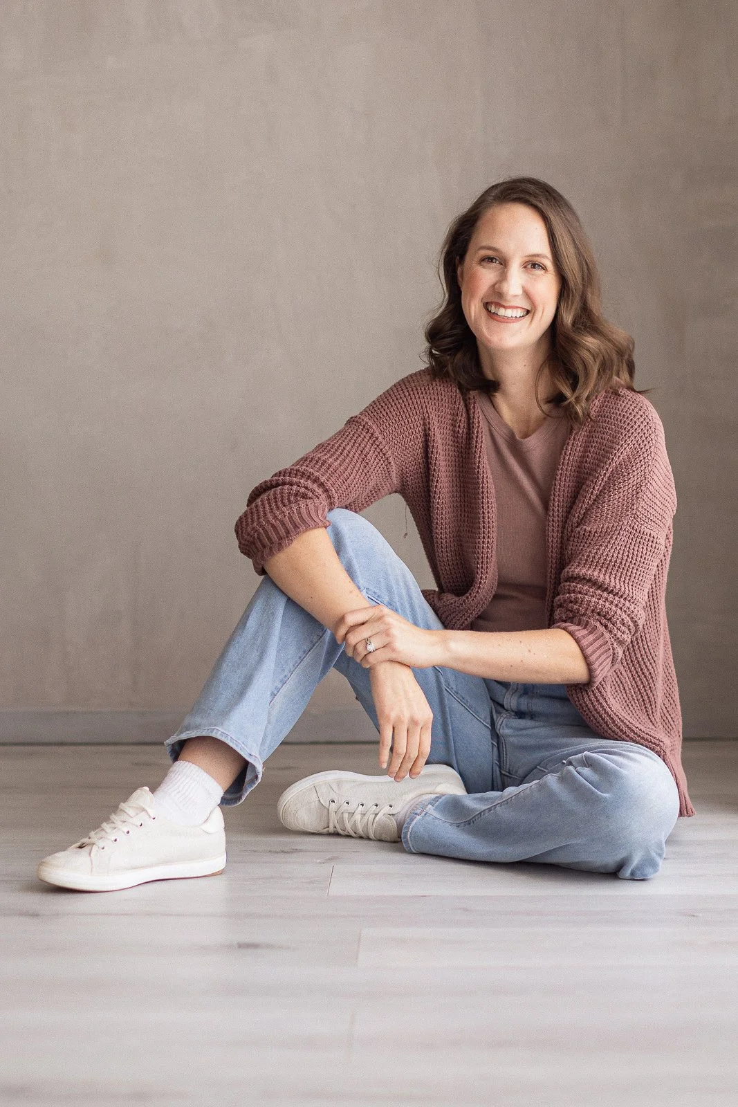 Portrait of Kelsey, an Orange County family photographer, seated in her Huntington Beach studio.