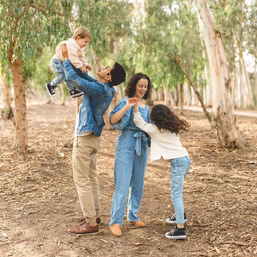 Playful movement photo in the eucalyptus grove at Serrano Creek Park in Lake Forest, a kid-friendly photo location.