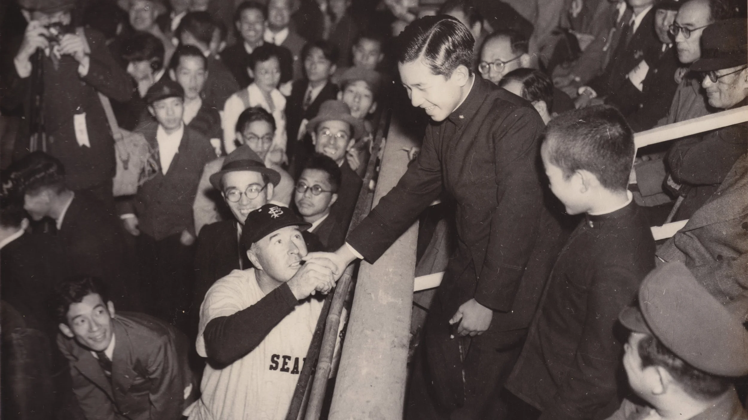 DIAMOND DIPLOMACY_02_During the 1949 San Francisco Seals_ goodwill tour of Japan, Lefty O_Doul, the team_s manager, shook hands with then-Crown Prince Akihito. Credit, Con Dempsey Collection, Courtesy of David Dempsey - Loi Ameera Almeron.jpg