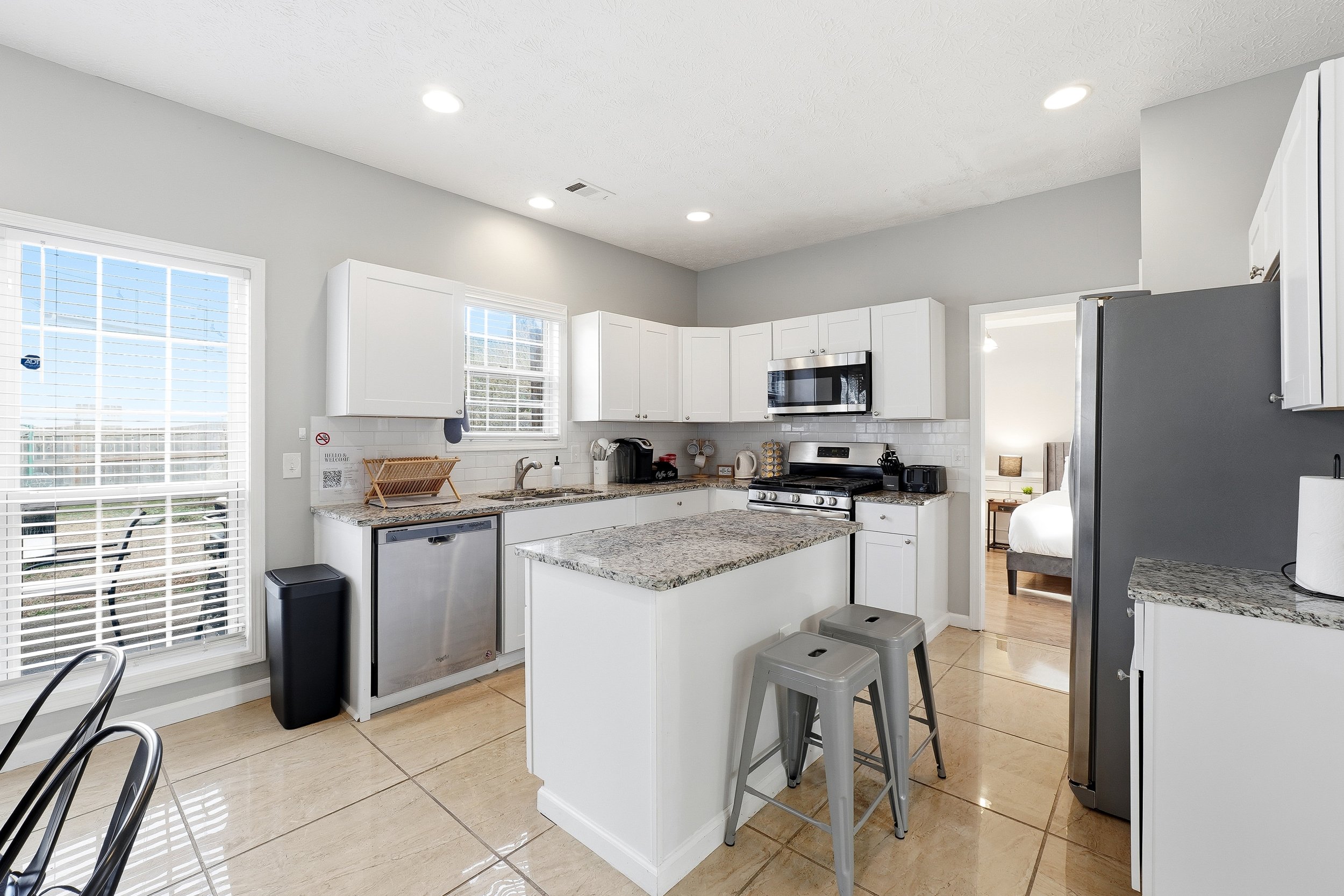 Kitchen with all your cooking needs. Plates, silverware, bowls, knife set, Keurig, baking pans and dishes, glasses, coffee mugs, measuring cups, and more. Full fridge and freezer, microwave, oven, and dishwasher.