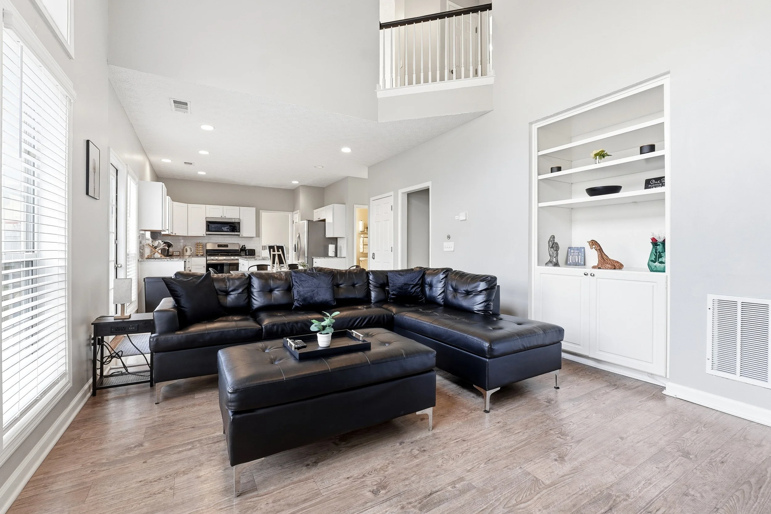 Bright and spacious living room with high ceilings, a Smart TV, and a cozy sectional for relaxing.