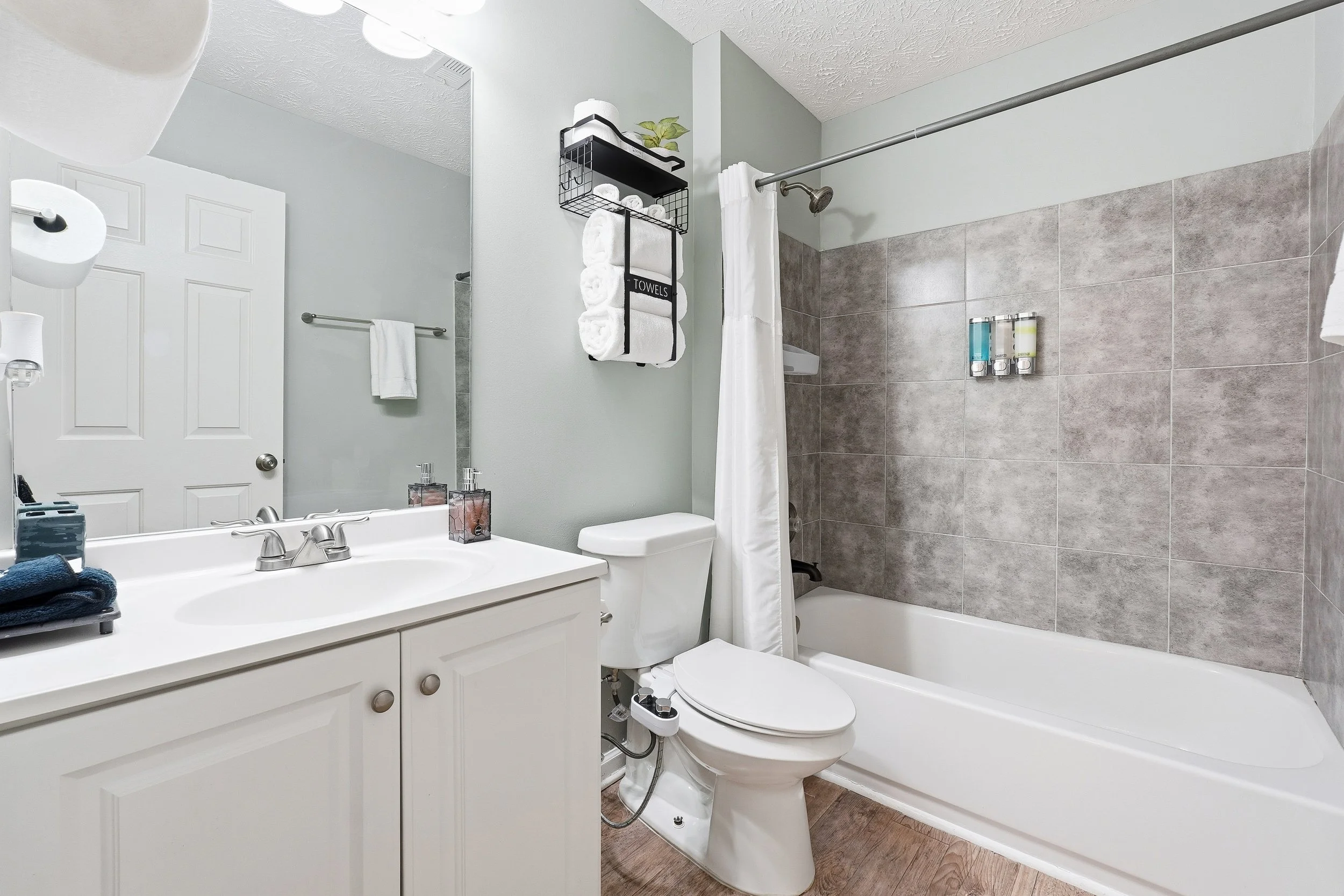 Bright and clean shared bathroom with a shower/tub combo — perfect for families or groups.