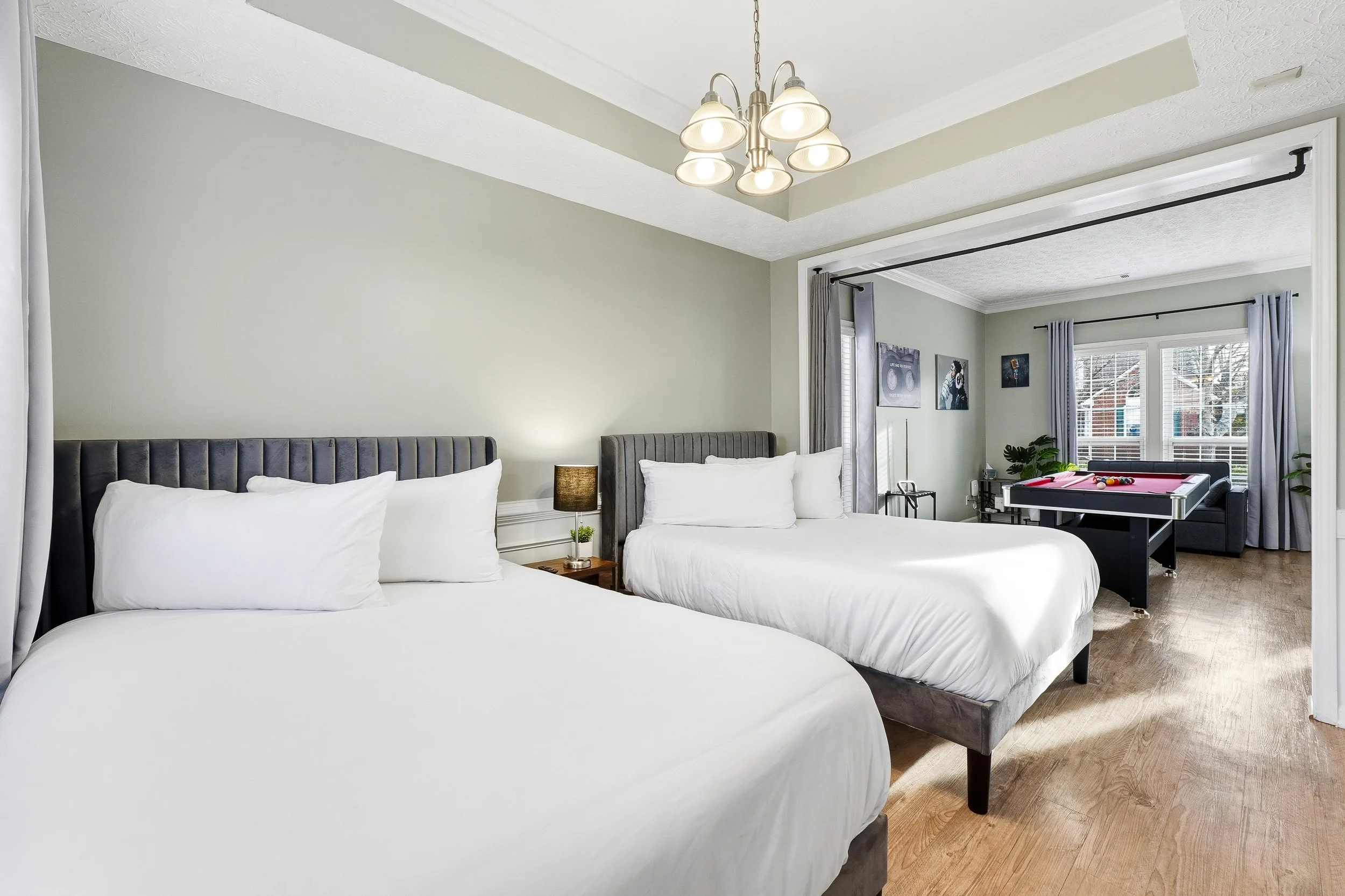 Bright bonus room featuring two double beds and built-in curtains for added privacy.