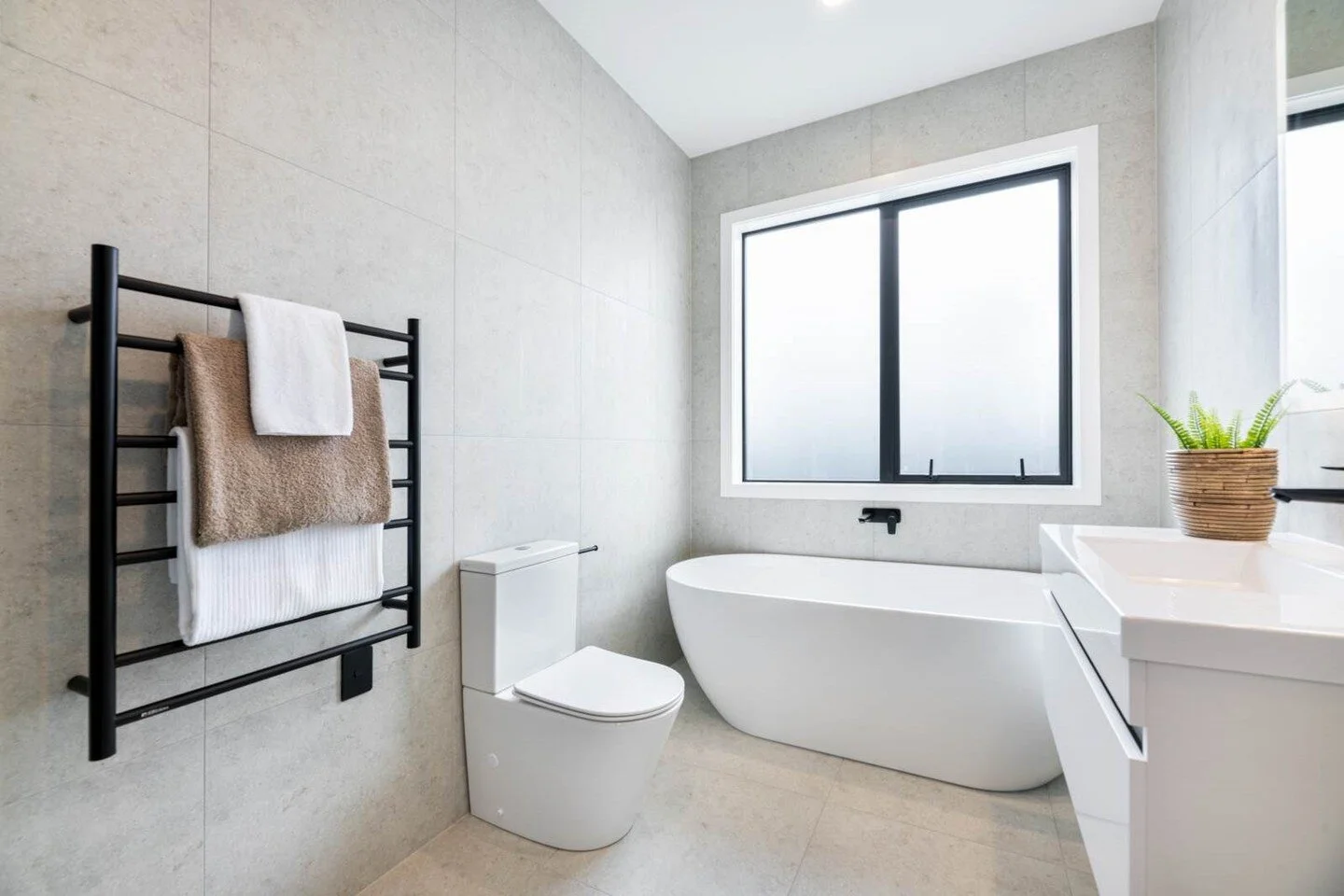 We love a Black accented bathroom! An added bonus of upgrading the electrical plates to black in order to keep cohesion throughout the space