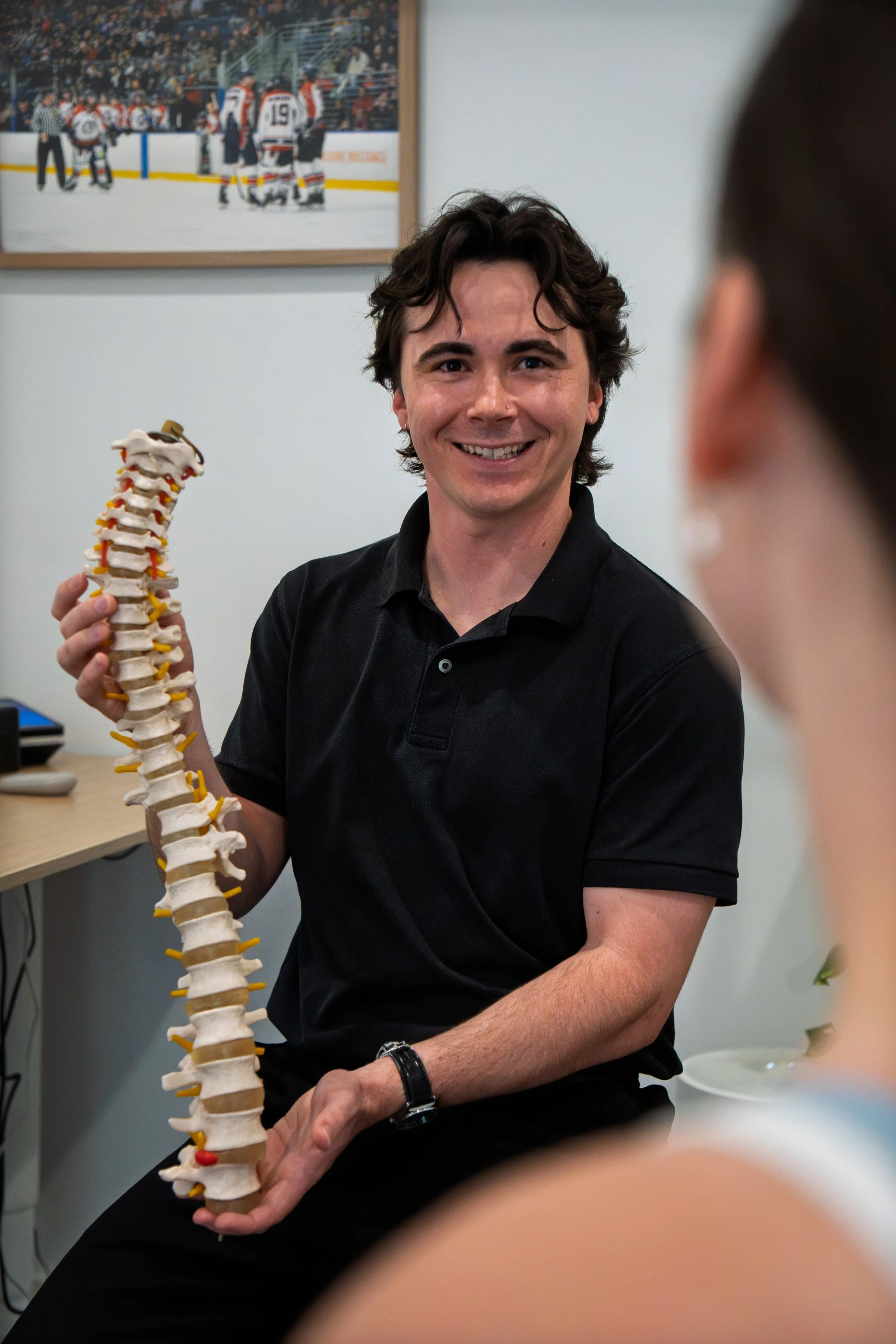 Dr Harry using a spine to explain pain