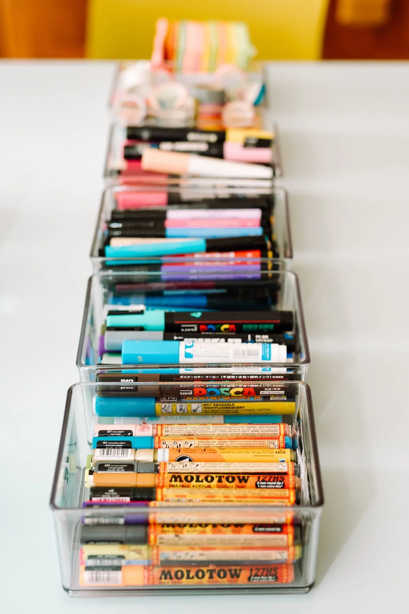 Pots full of art pens in a row, creative materials often used by creative businesses