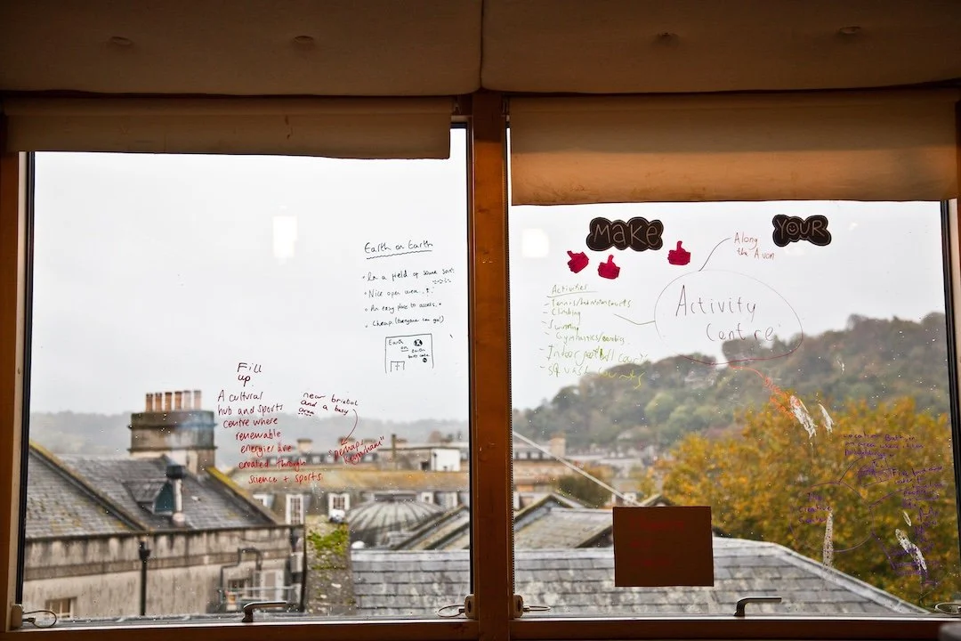 A workshop I provided facilitation support for at The Egg Theatre in Bath encouraged young people to imagine how they would improve their home town of Bath. Ideas were drawn up on the windows