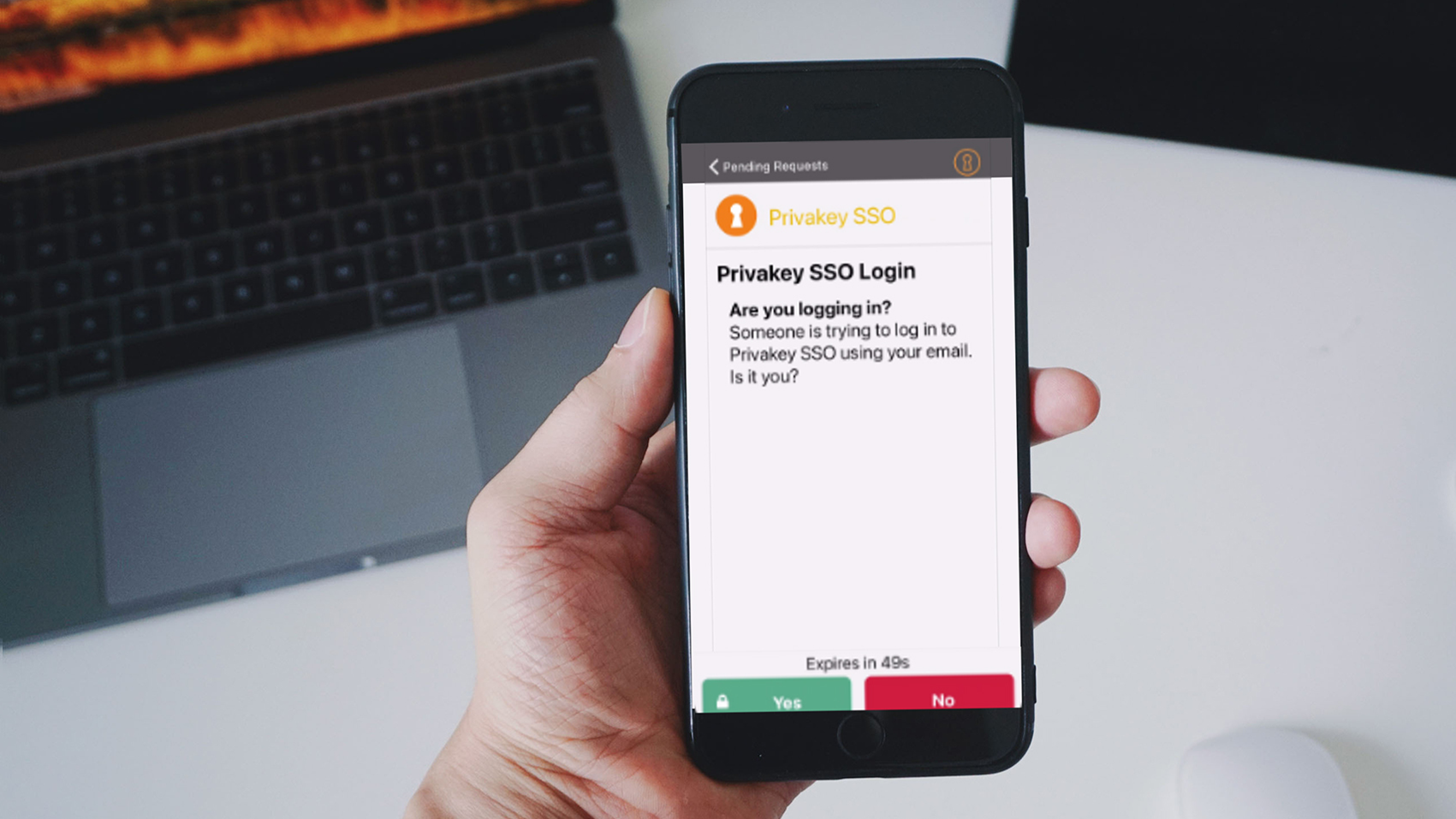  A person holding an iPhone and there is the PrivaKey SSO Login confirmation page asking if the login attempt was the user’s. 