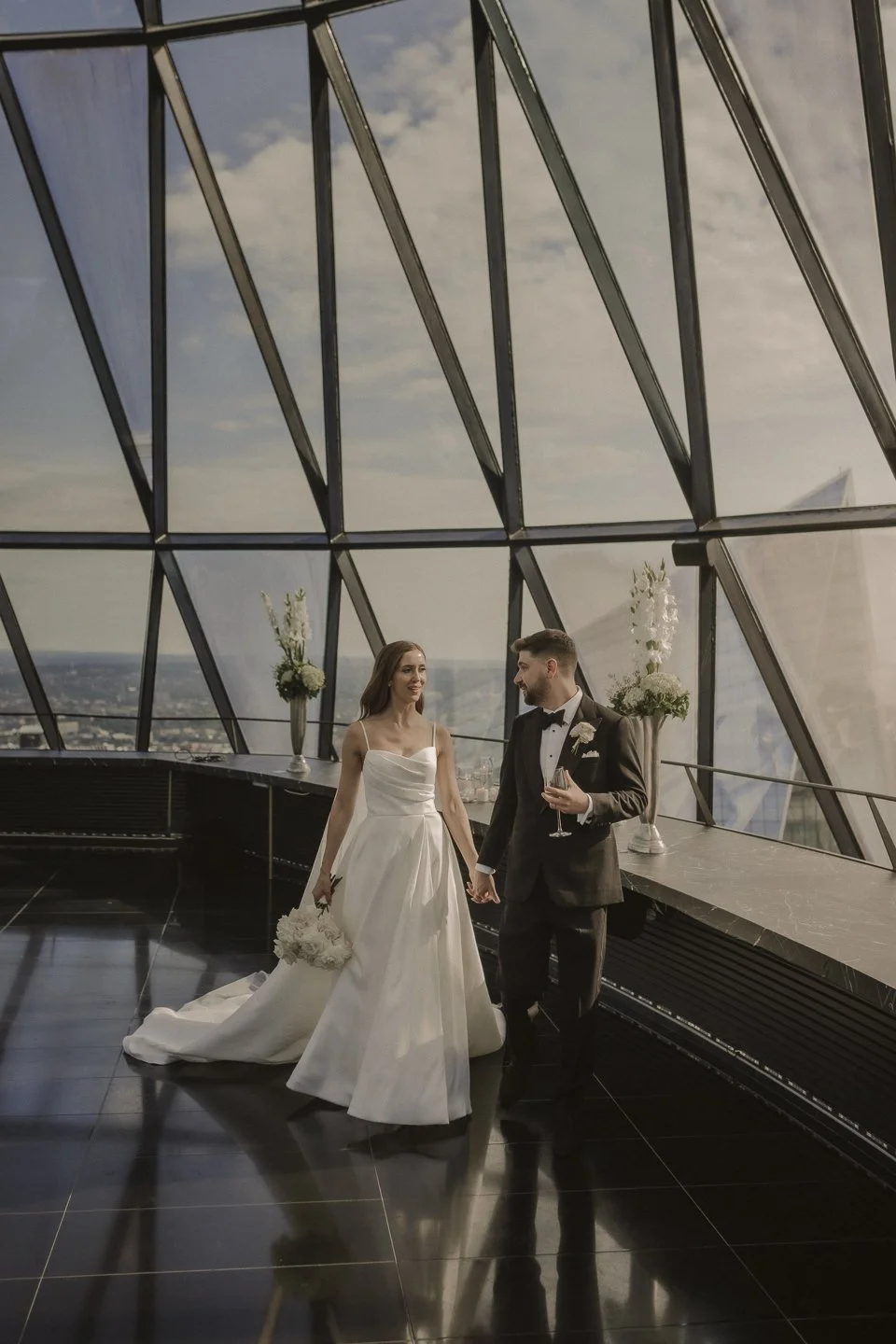 Bride and groom framed by modern architecture overlooking the London skyline