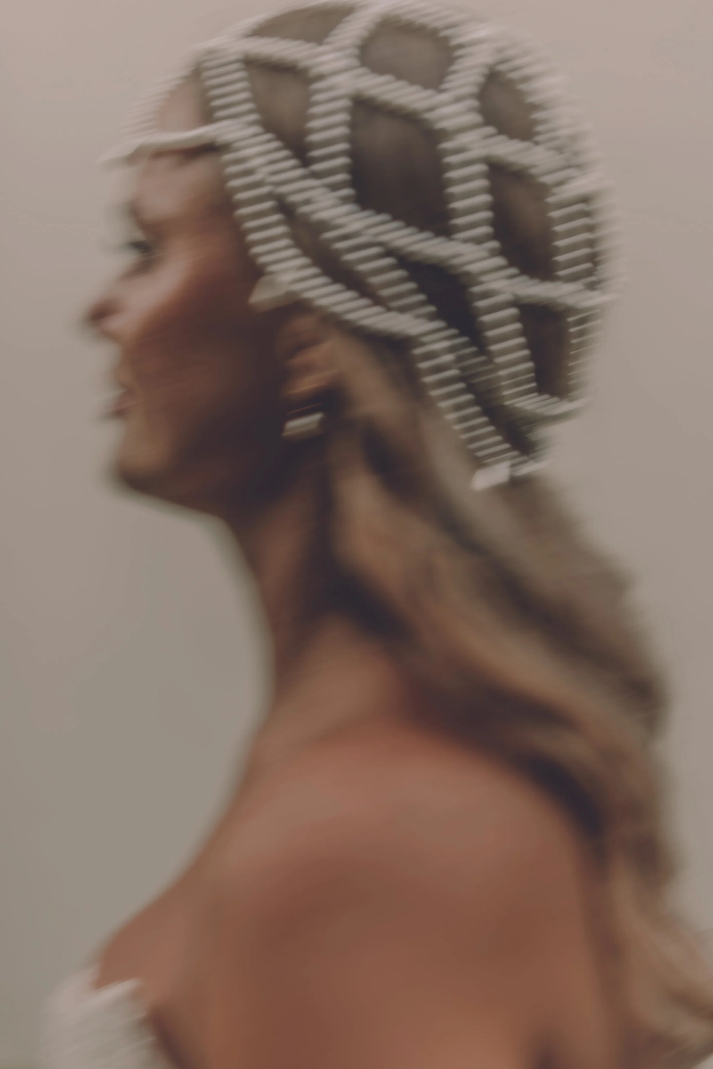 Bride wearing a statement headpiece photographed with intentional motion blur