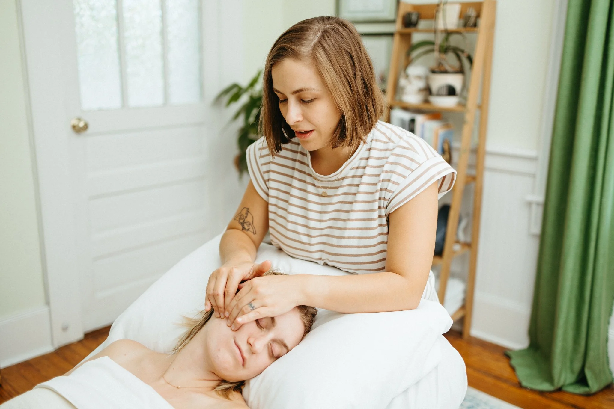 Shannon performing somatic face massage for a pregnant client