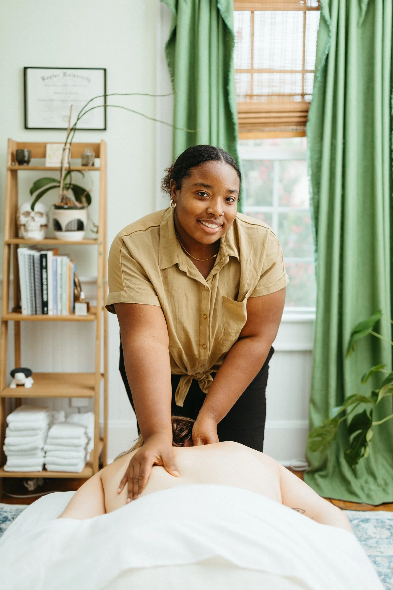 Lydia performing integrative massage on a client's back and neck