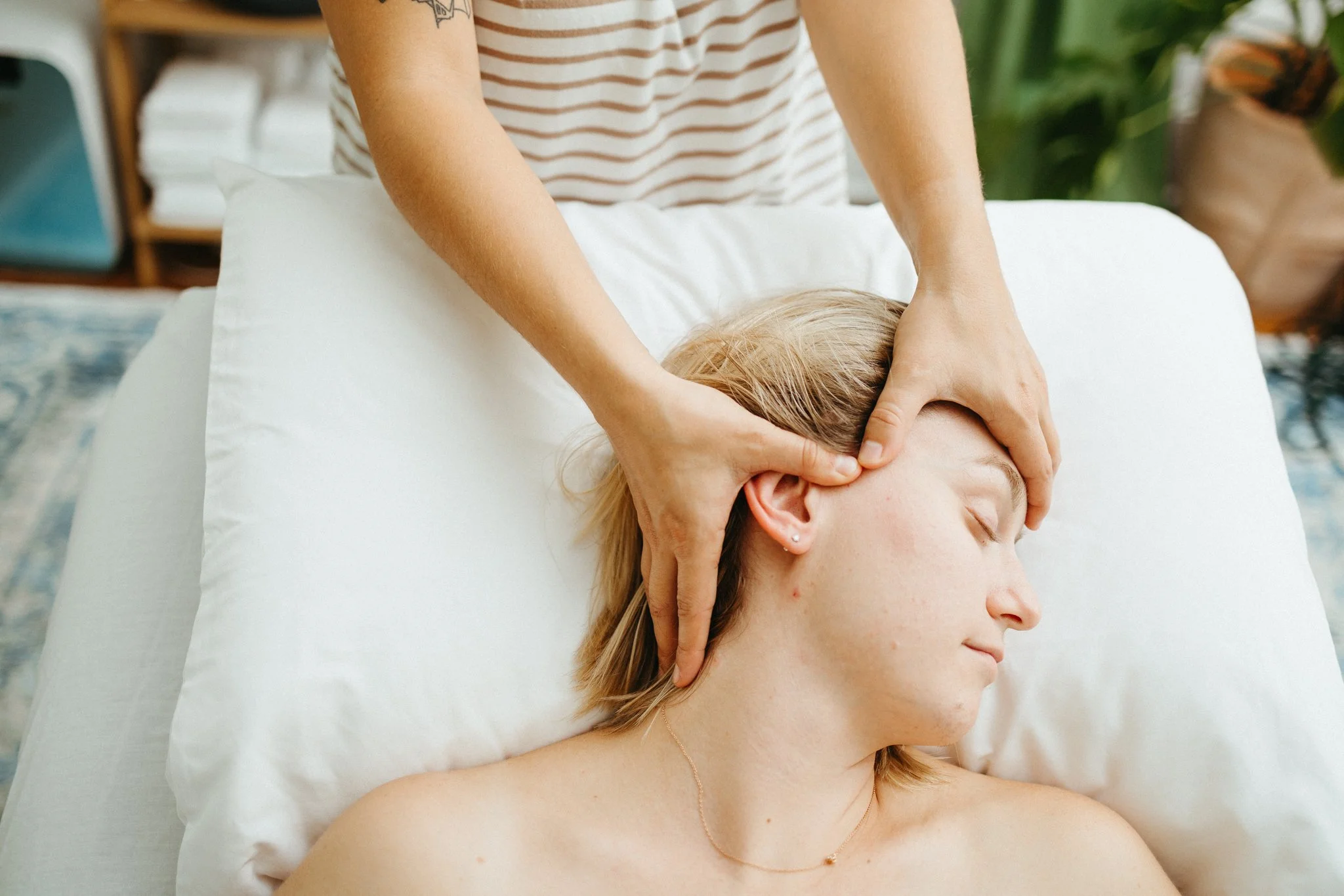 Shannon giving a prenatal massage with somatic face massage and gua sha scalp massage