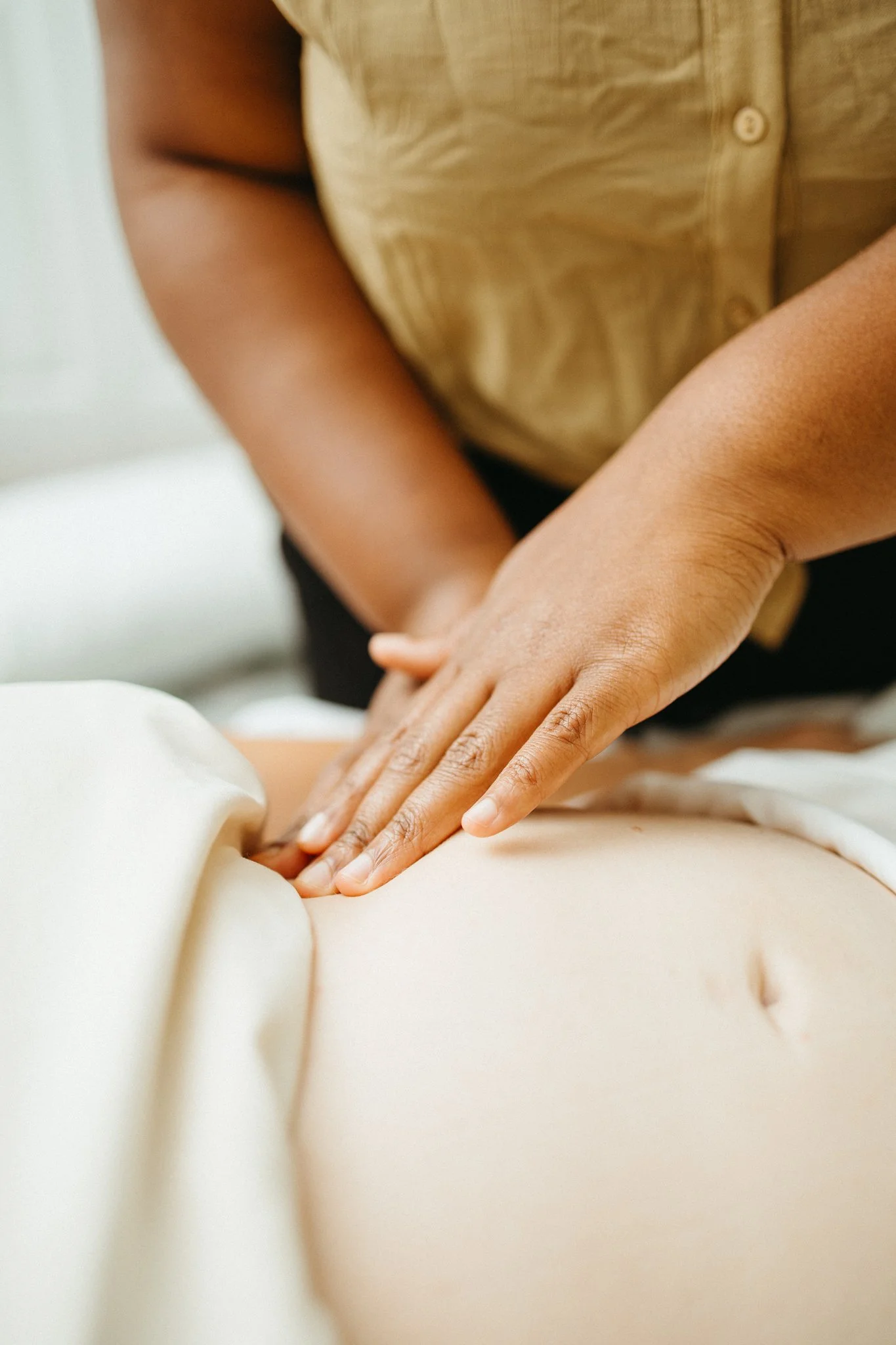 Lydia performing abdominal massage to help client breathe better during pregnancy