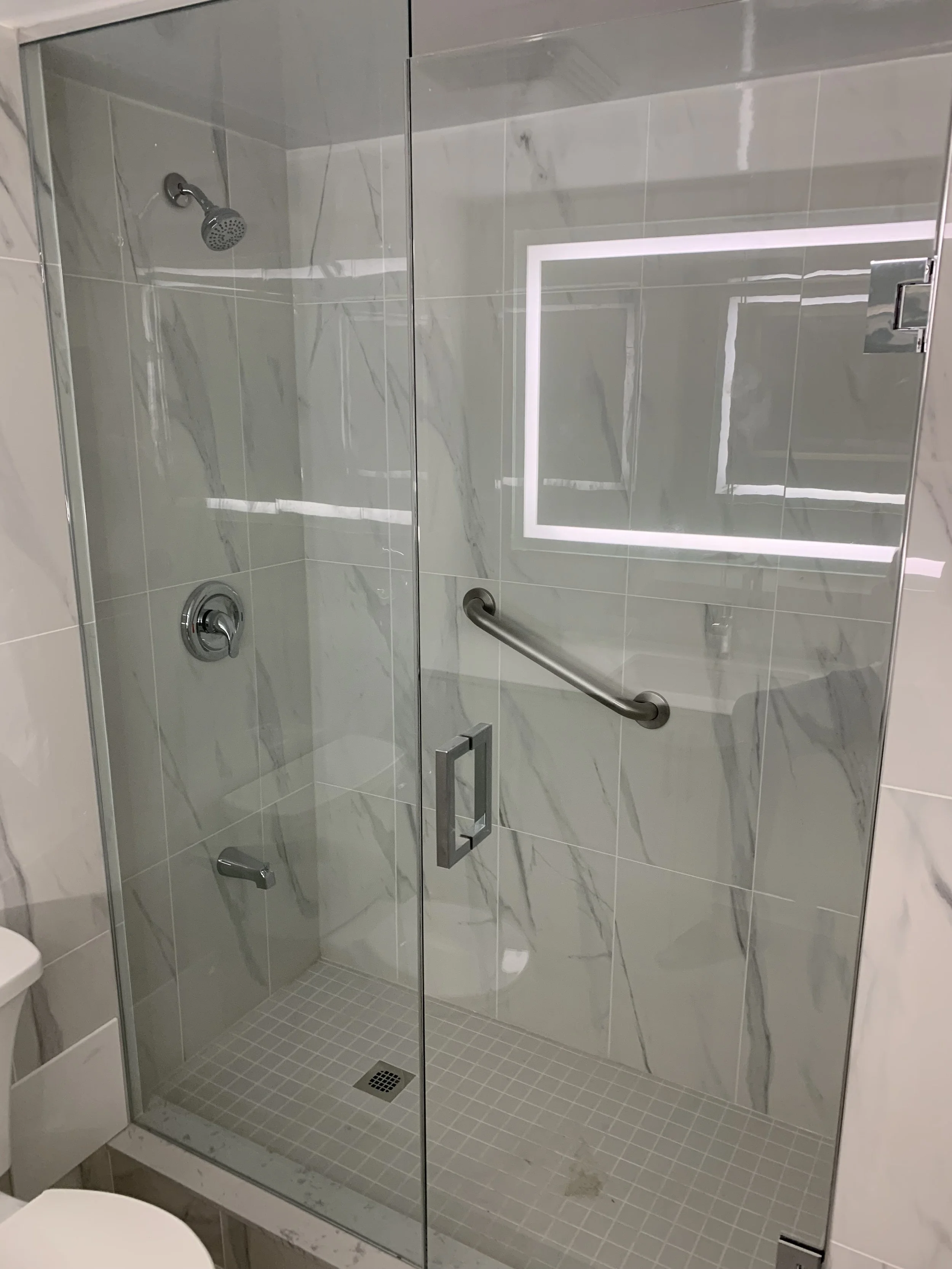 Walk in shower with marble tiles