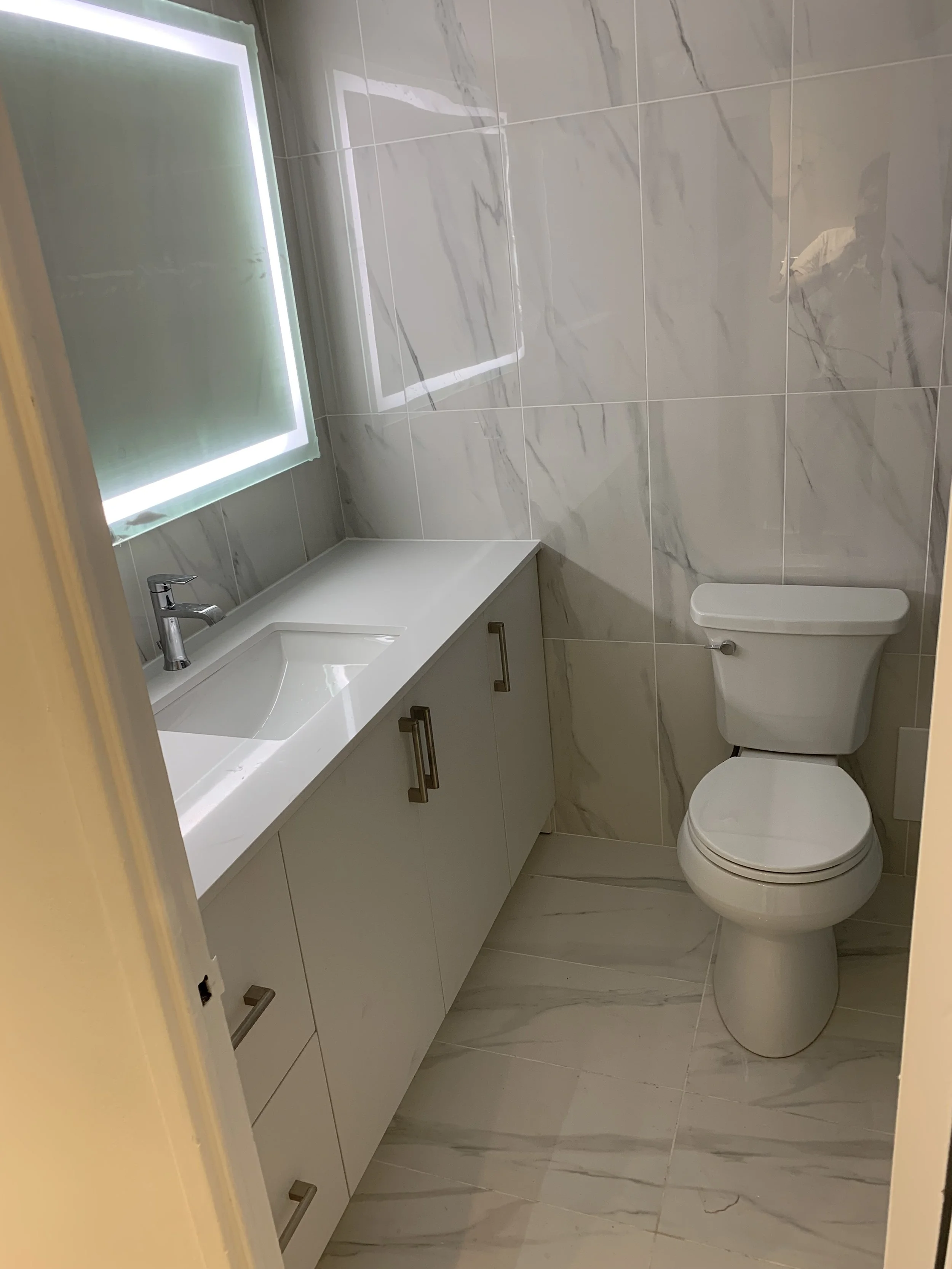 White constructed bathroom with LED mirror and vanity