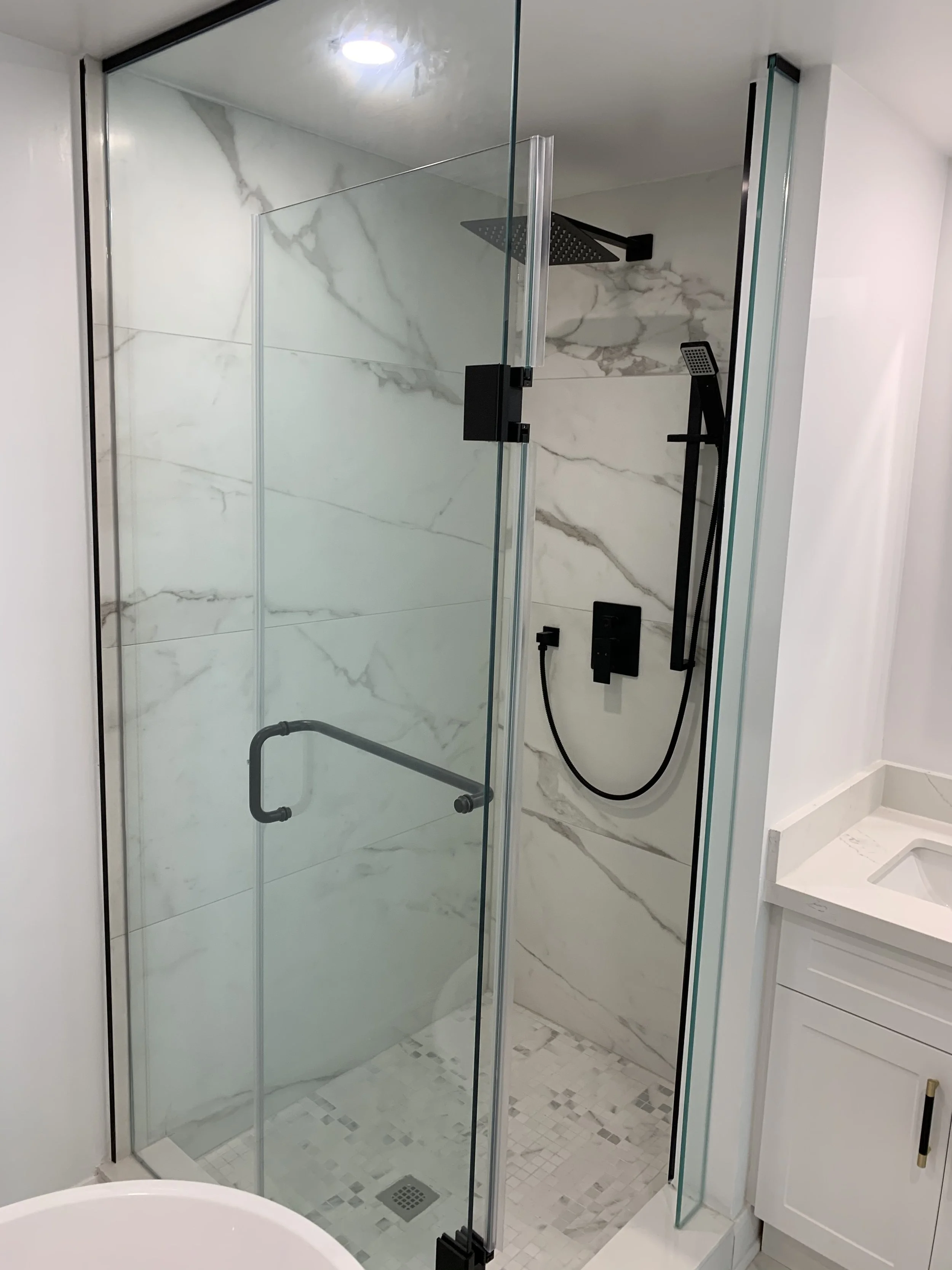 Newly constructed standing shower with white tiles