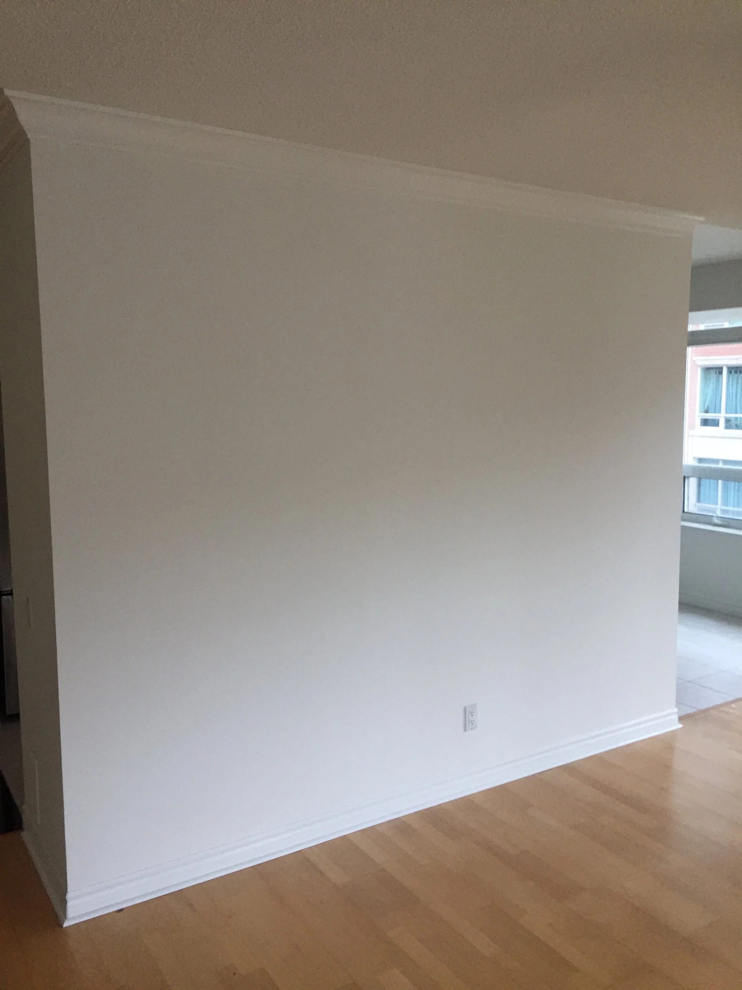 Condo before the renovation is completed showing the wall to separate the kitchen and living room