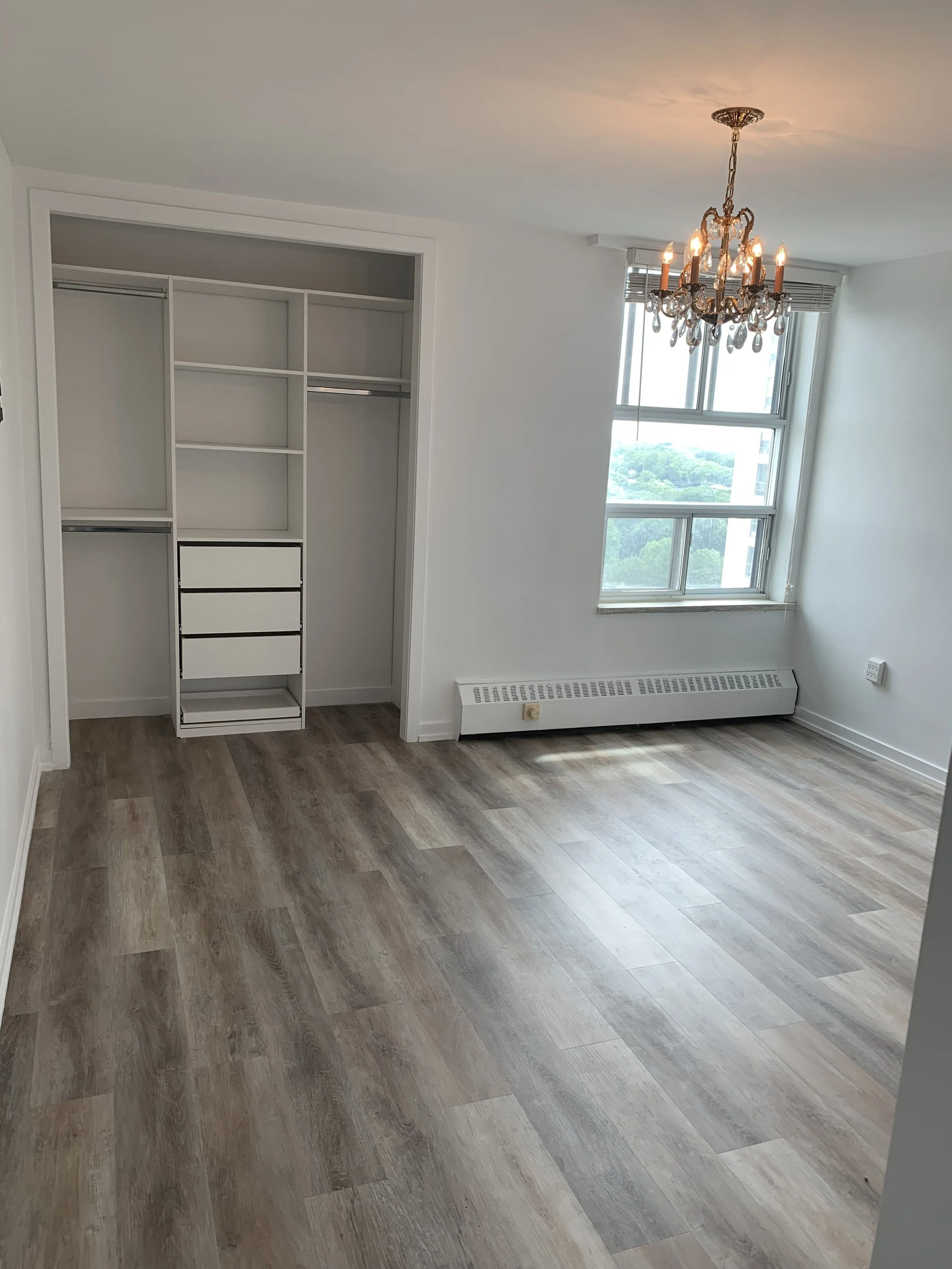 Bedroom renovated with a walk in closet and new floors
