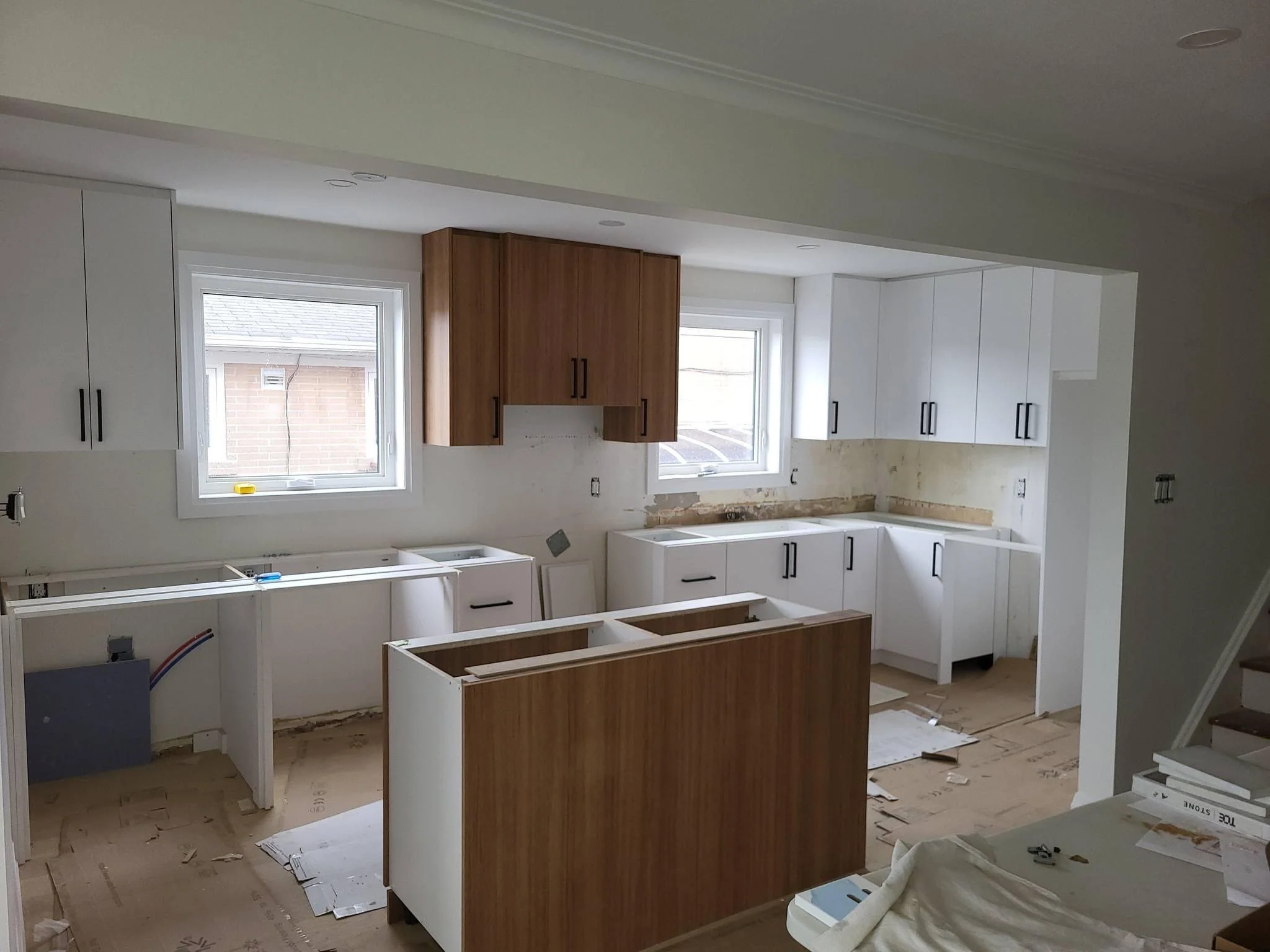 Brown and white kitchen cabinet installation