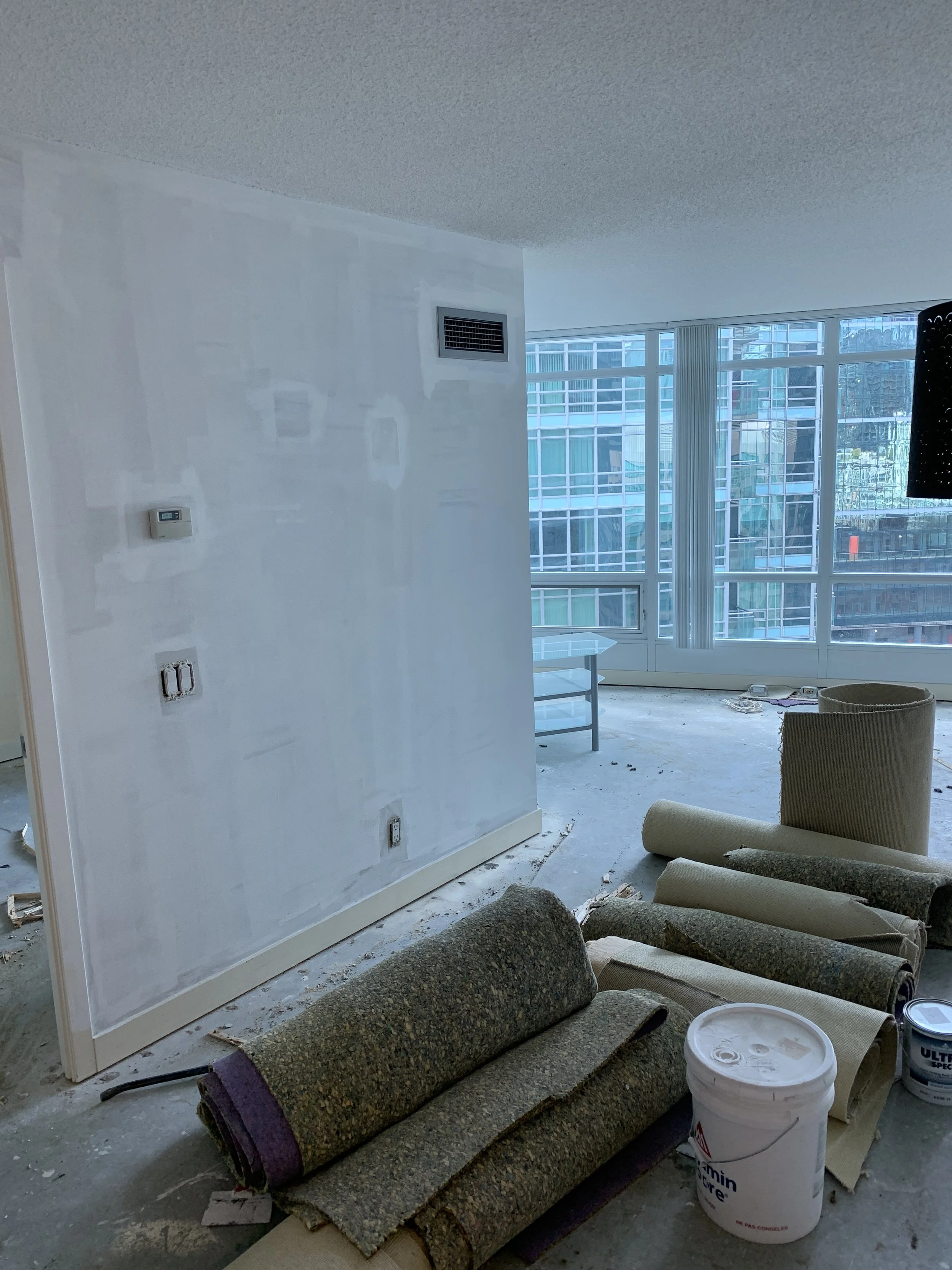 Plastered walls waiting to be painted, old floors removed