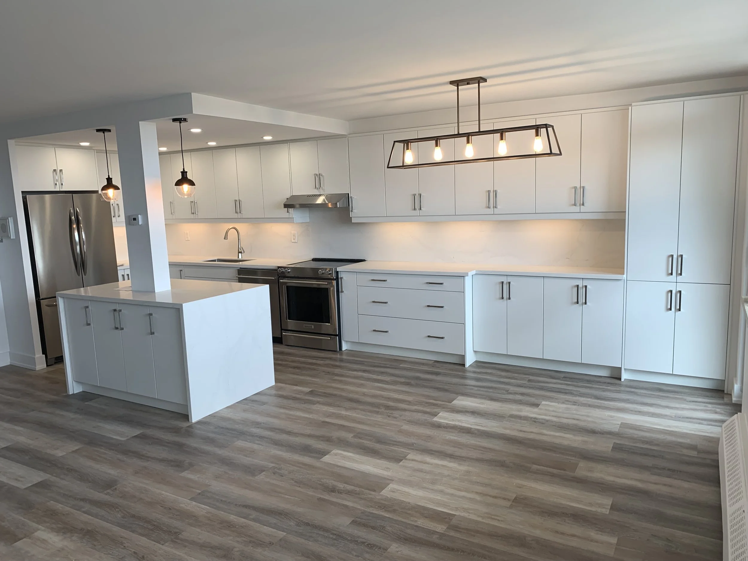 White kitchen with new cabinets and flooring
