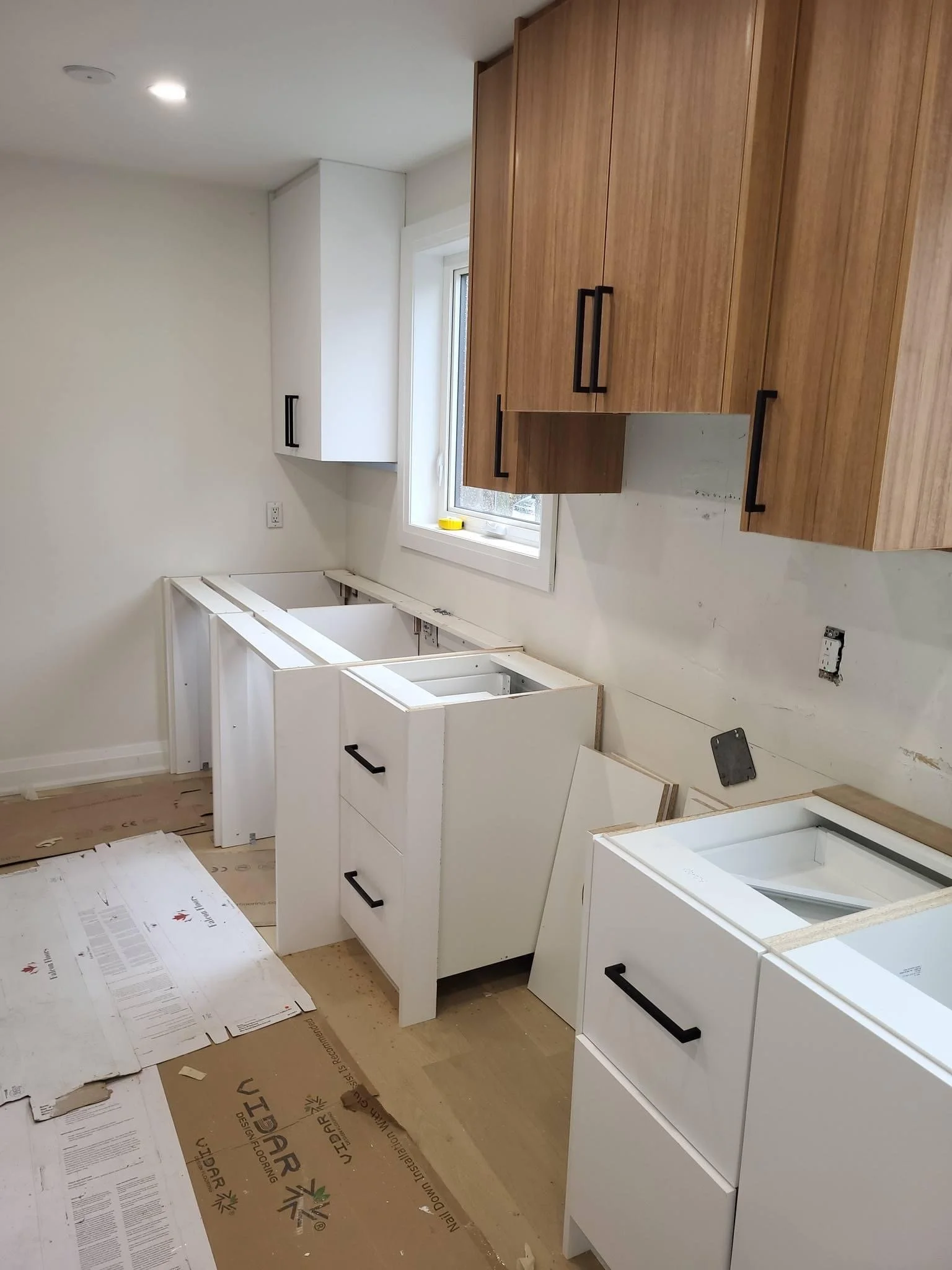Kitchen cabinets being installed during renovation