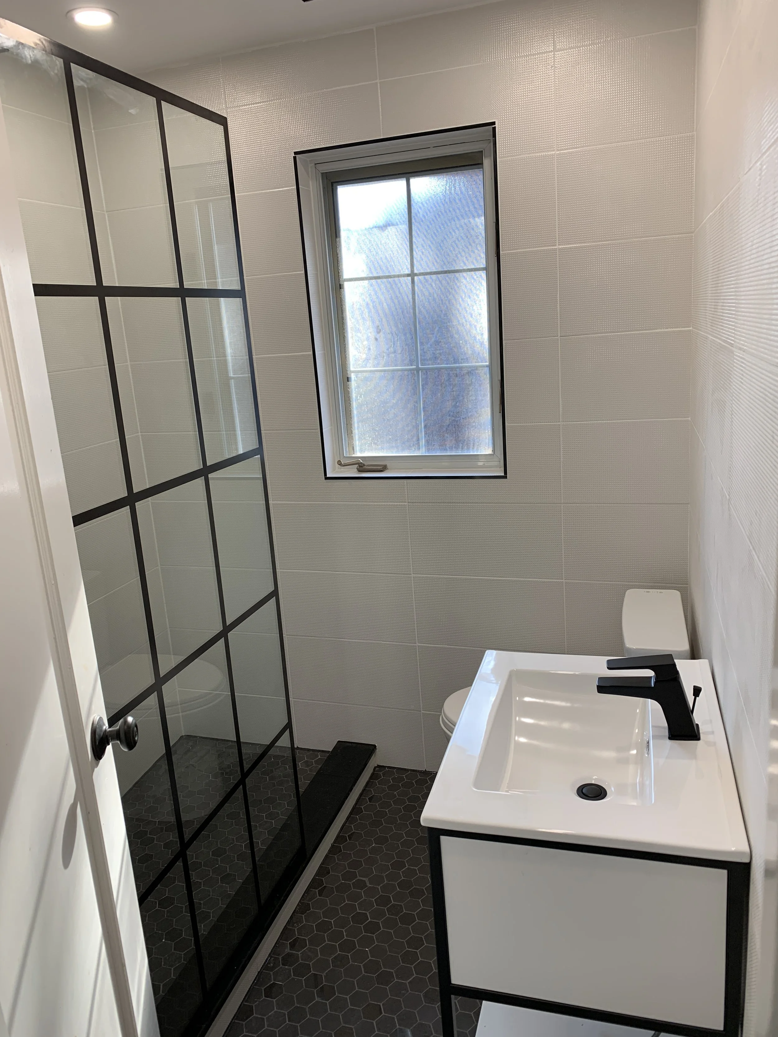 Leaside bathroom project with modern tiles, window, and fresh vanity