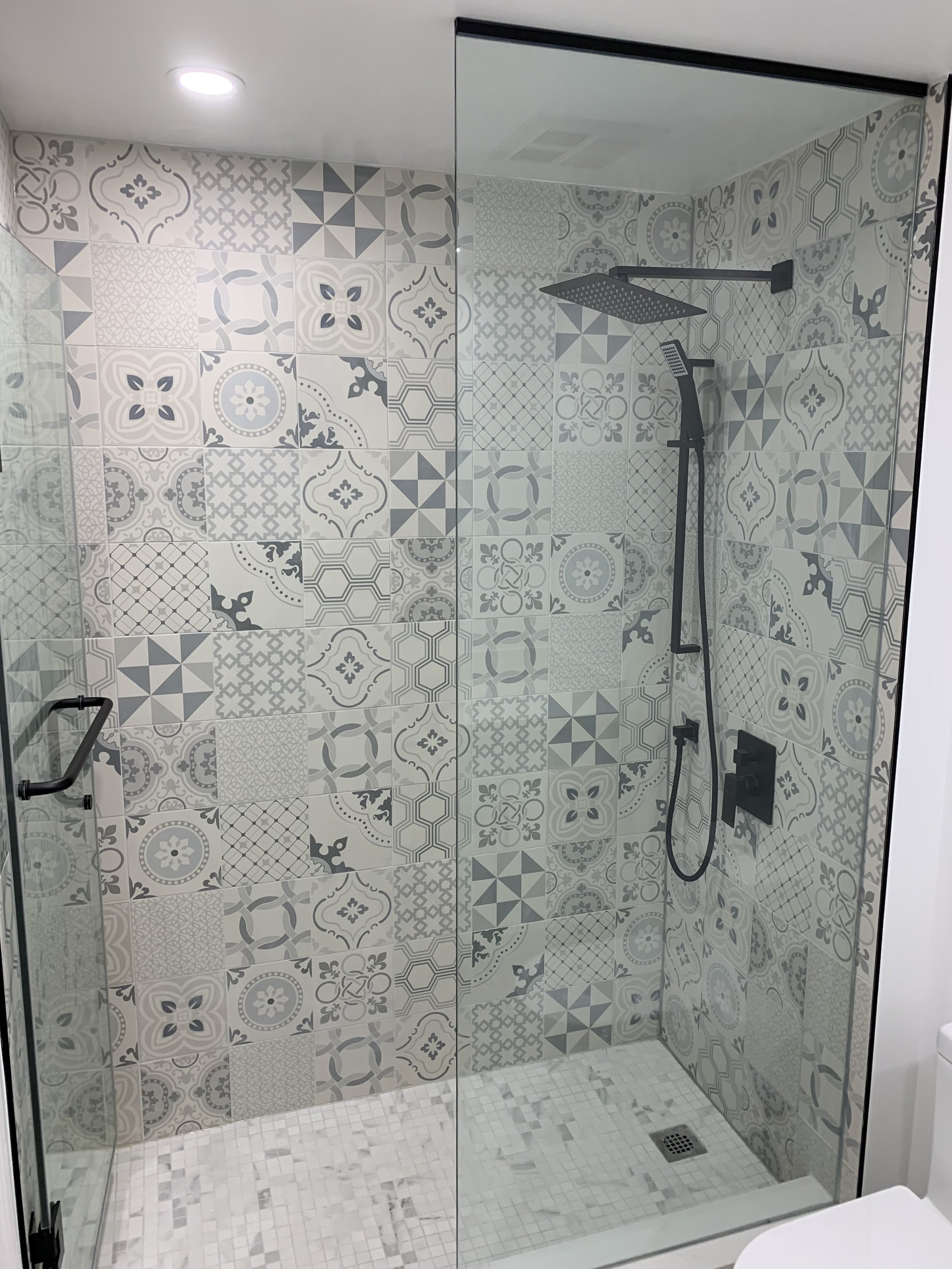 New standing shower in a renovated bathroom with fresh wall tiles